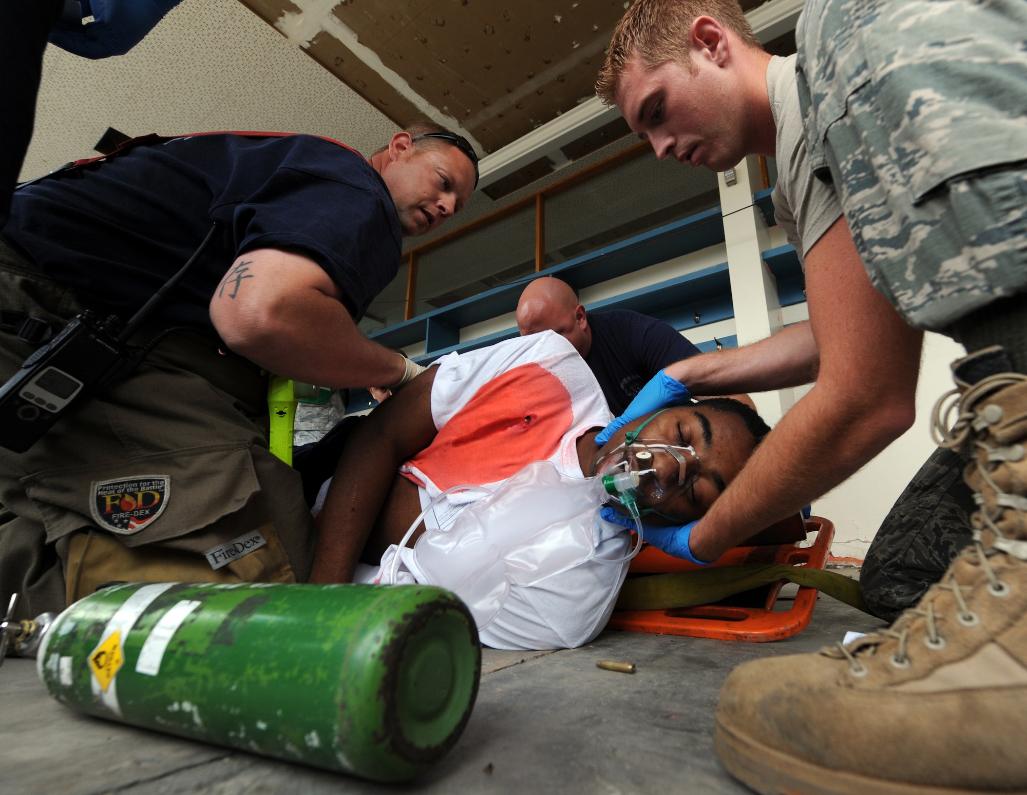 MOUNTAIN HOME AIR FORCE BASE, Idaho –Airman 1st Class Donnell Jackson’s, 366th Comptroller Squadron, is placed on a stretcher by members of the 366th Civil Engineer Squadron Fire Department after suffering a simulated sucking chest wound during an exercise a t the base primary school Sept, 8. Mountain Home AFB uses simulated exercises to increase their readiness and ability to take appropriate measures to protect our people and resources during real-world situations. (U.S. Air Force photo by Senior Airman Debbie Lockhart)