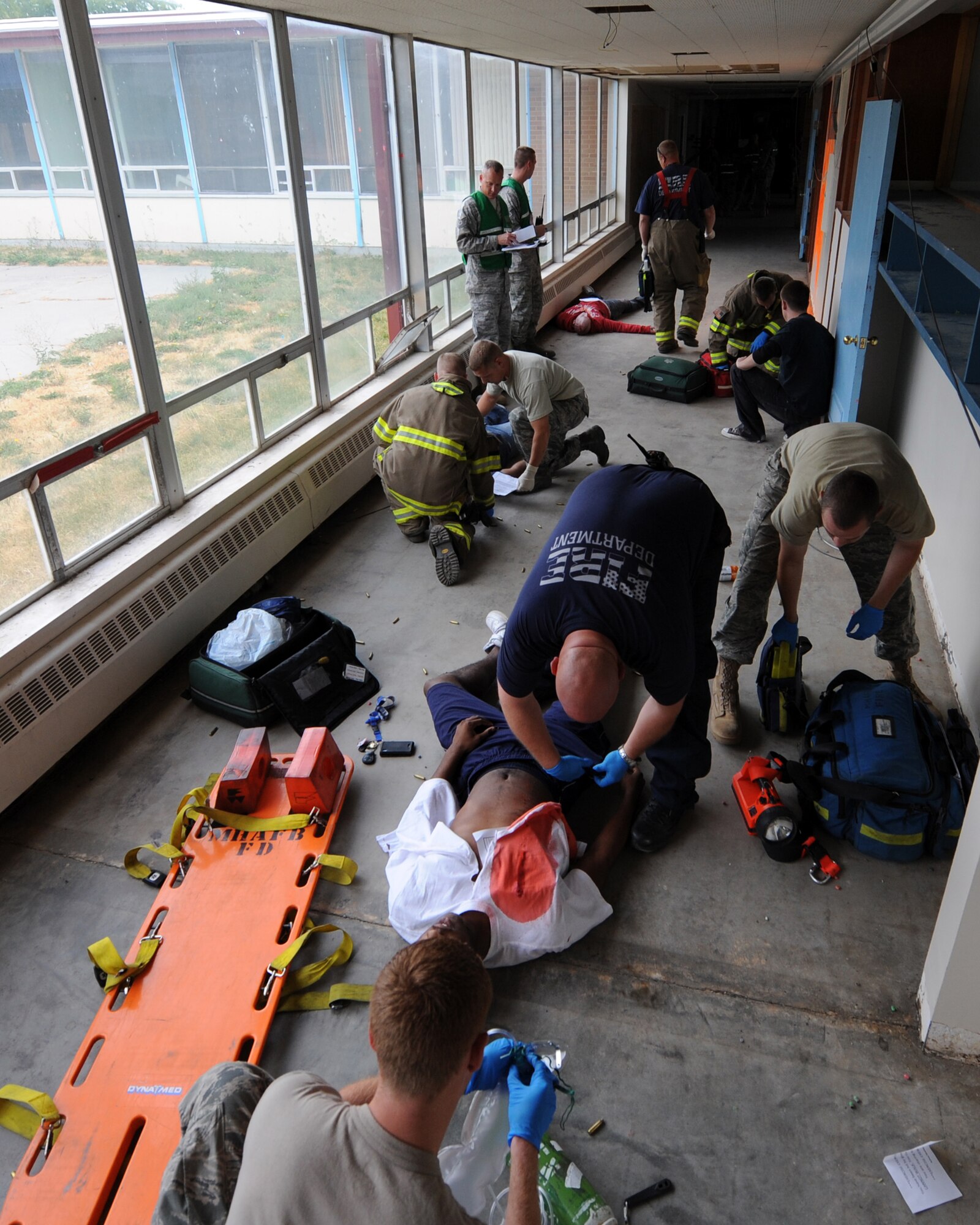 MOUNTAIN HOME AIR FORCE BASE, Idaho – Members of the 366th Civil Engineer Squadron Fire Department asses simulated injuries at the base primary school during an exercise Sept, 8.  Mountain Home AFB uses simulated exercises to increase their readiness and ability to take appropriate measures to protect our people and resources during real-world situations. (U.S. Air Force photo by Senior Airman Debbie Lockhart)