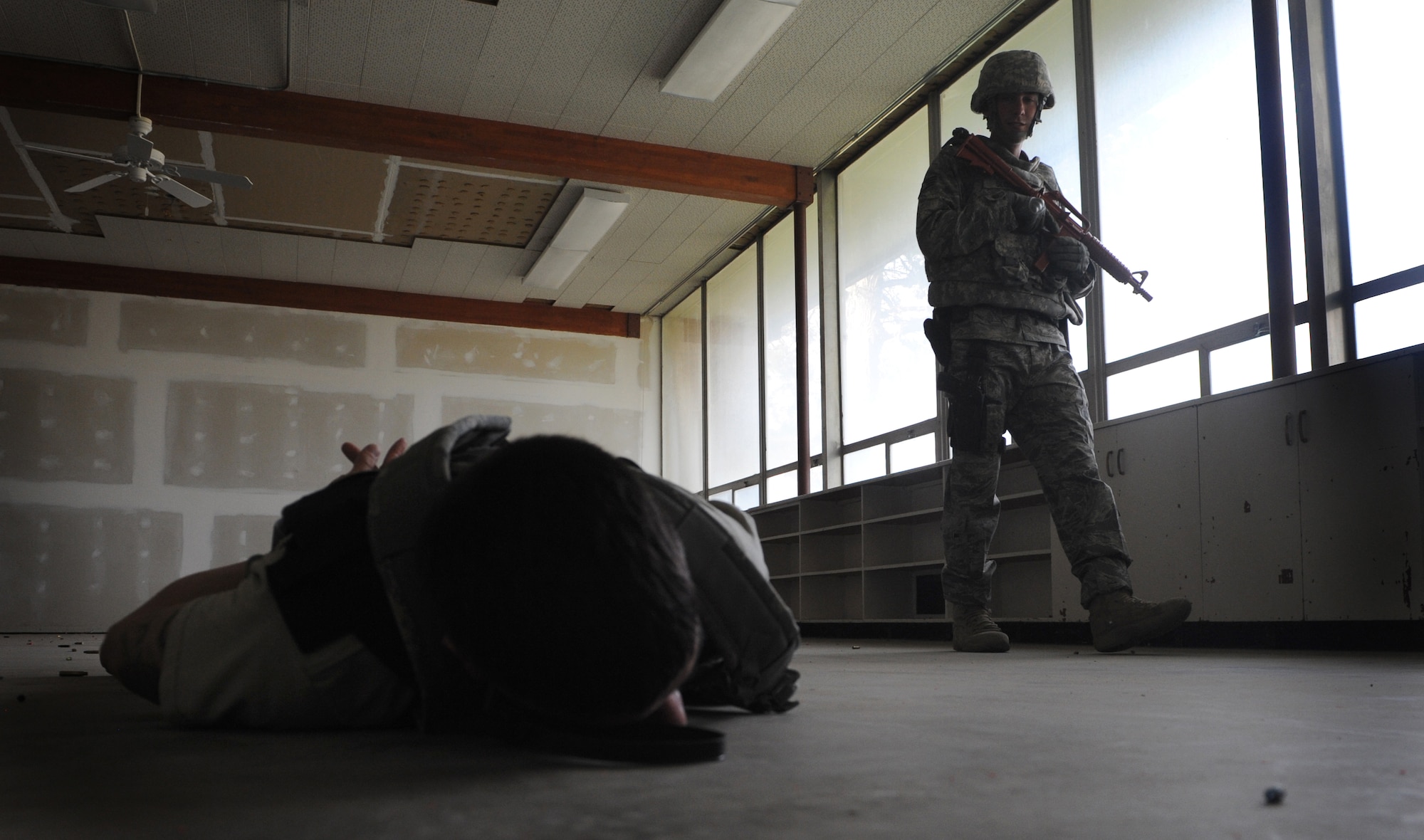 MOUNTAIN HOME AIR FORCE BASE, Idaho – Staff Sgt. John Sloan, 366th Security Forces Squadron patrolman, guards a gunman after shots were fired at the base primary school during an exercise Sept, 8.  Mountain Home AFB uses simulated exercises to increase their readiness and ability to take appropriate measures to protect our people and resources during real-world situations. (U.S. Air Force photo by Senior Airman Debbie Lockhart)