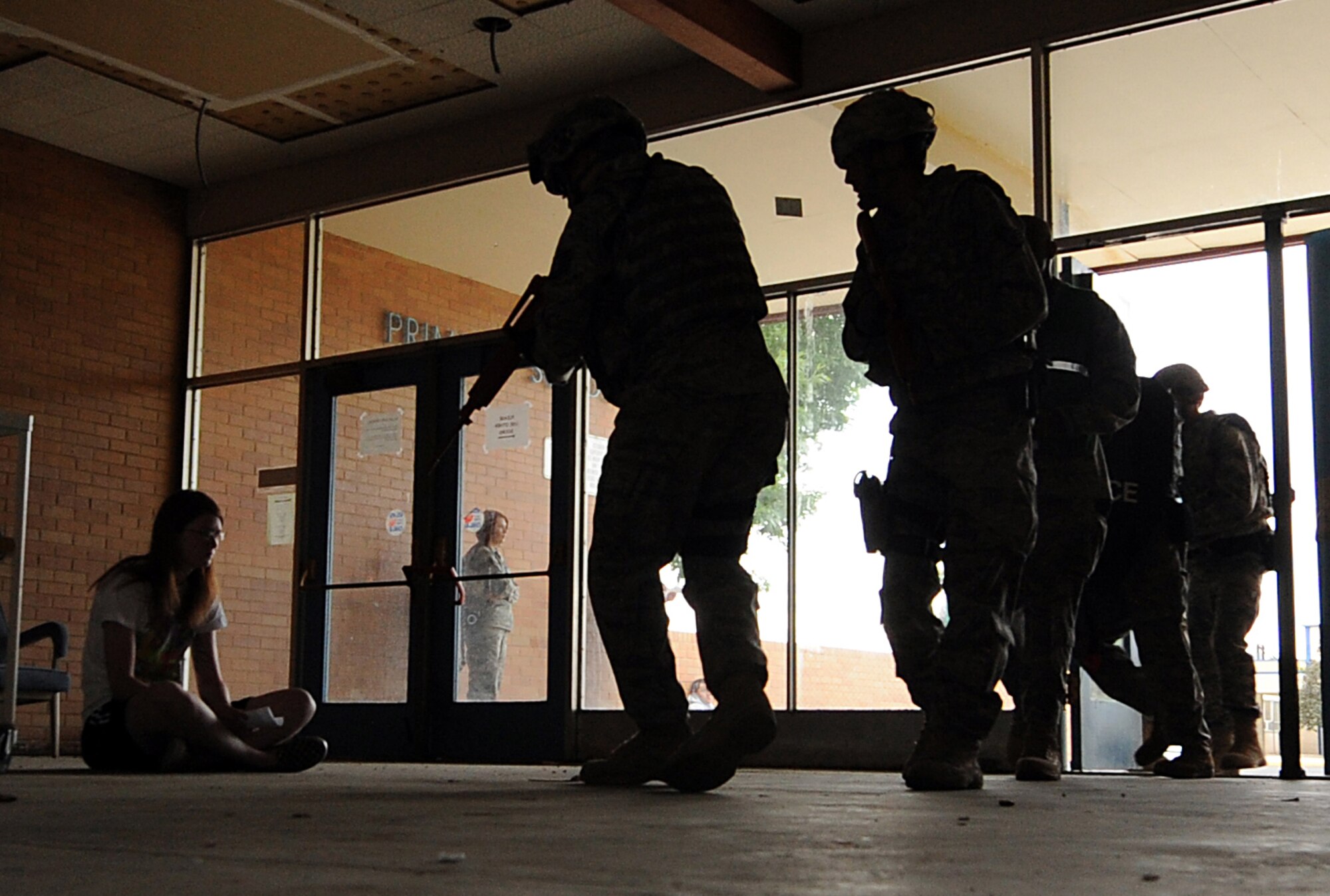 MOUNTAIN HOME AIR FORCE BASE, Idaho – Members of the 366th Security Forces Squadron rush into the base primary school to simulate clearing a building after a gunman fired shots during an exercise Sept, 8.  Mountain Home AFB uses simulated exercises to increase their readiness and ability to take appropriate measures to protect our people and resources during real-world situations. (U.S. Air Force photo by Senior Airman Debbie Lockhart)