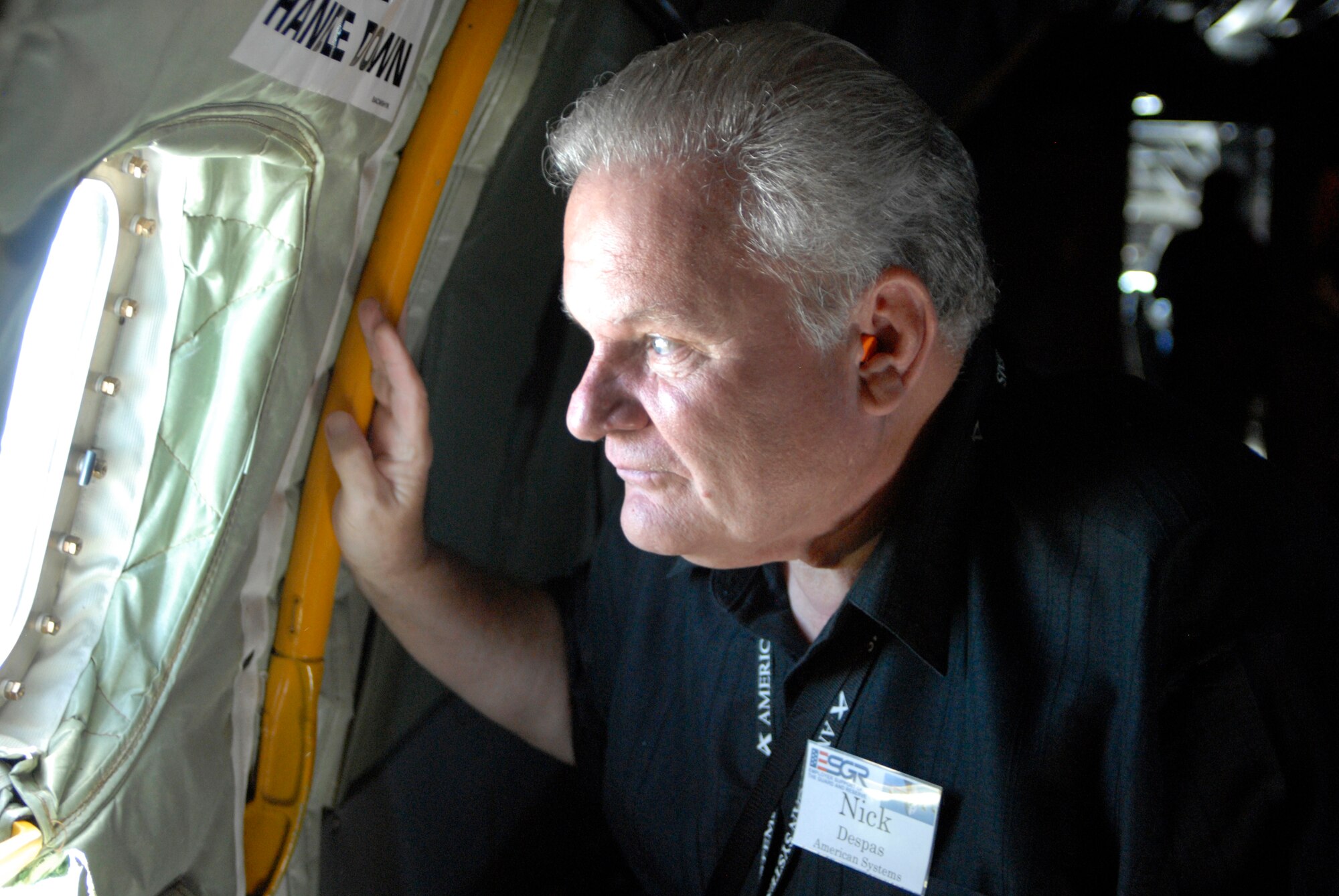 WRIGHT-PATTERSON AIR FORCE BASE, Ohio – Mr. Nick Despas, American Systems, looks through a window at the scenery while on board the flight deck of a KC-135 Stratotanker from the 121st Air Refueling Wing, Rickenbacker Air National Guard Base, Ohio, for an ESGR Boss-Lift flight Aug 12. (U.S. Air Force photo/Maj. Jose Cardenas)