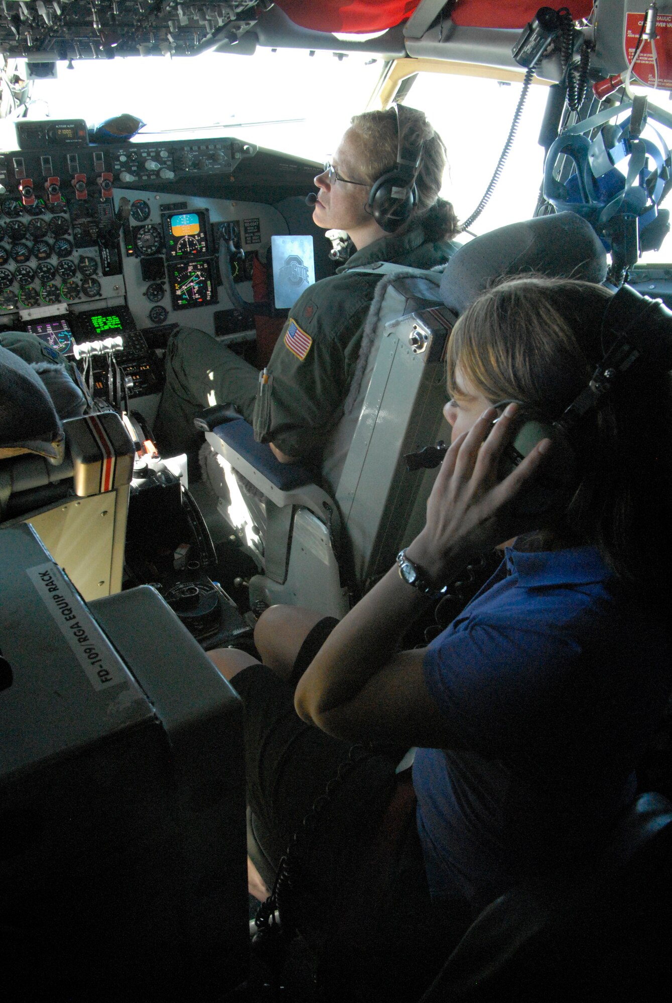 WRIGHT-PATTERSON AIR FORCE BASE, Ohio – Ms. Jane Krebs, Generation Dayton, looks over the controls and scenery while on board the flight deck of a KC-135 Stratotanker with Maj. Barb Bartch, assigned to the 121st Air Refueling Wing, Rickenbacker Air National Guard Base, Ohio, for an ESGR Boss-Lift flight Aug. 12. (U.S. Air Force photo/Maj. Jose Cardenas) 