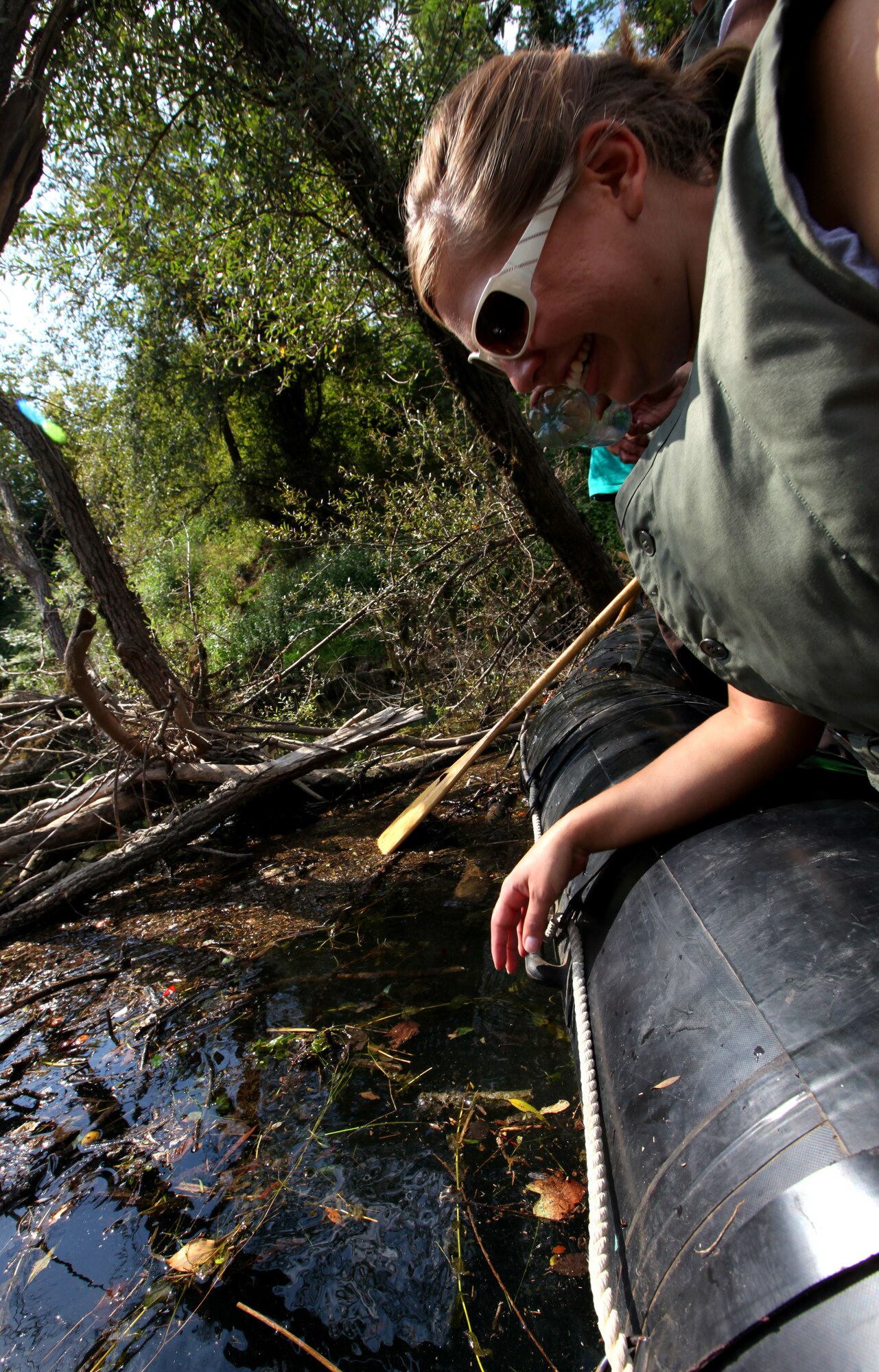 Airman 1st Class Kimberly Walls, 48th Medical Support Squadron medical logistics technician from RAF Lakenheath, England, peers over the edge of a boat during a river clean-up outside Danilovgrad, Montenegro, Sept. 8. Airman Walls is part of the Medical Training Exercise in Central and Eastern Europe 2010. MEDCEUR 2010 brings together nine central and eastern European nations for a series of joint activities meant to improve medical mass casualty operation, planning and coordination skills. For more information, visit www.usafe.af.mil/medceur.asp and www.odbrana.gov.me. (U.S. Marine Corp photo/Lance Cpl. Jad Sleiman)