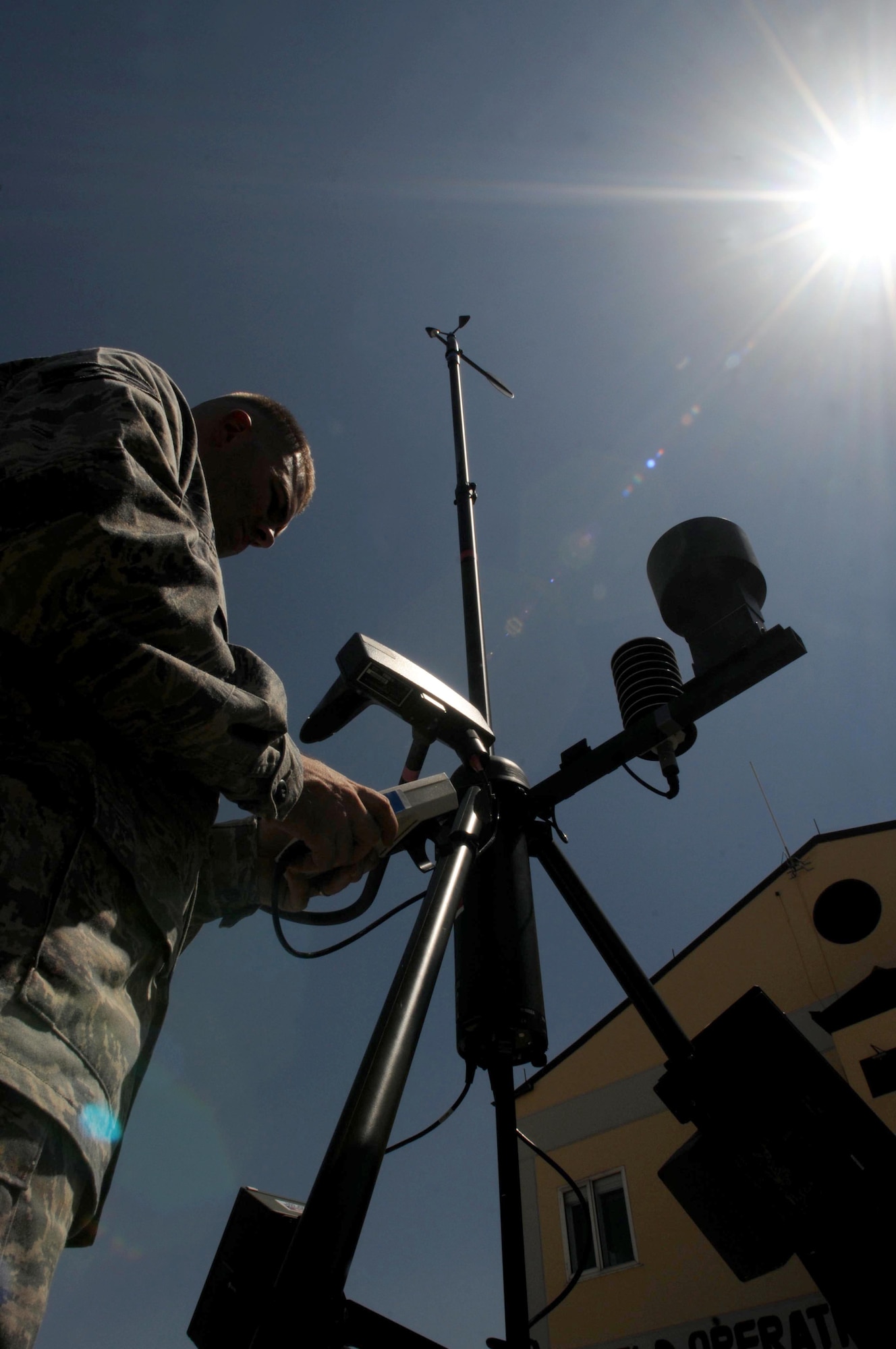Staff Sgt. Jeffrey Robbins, 39th Operations Squadron weather technician, measures wind direction with a handheld monitor on a Tactical Meteorological Observing System Aug. 25, 2010 at Incirlik Air Base, Turkey.  The TMOS is a tactical, deployable weather sensing device the Air Force uses to collect real-time weather data from austere locations, forward operating bases and remote sites. (U.S. Air Force photo by Senior Airman Ashley Wood/Released)