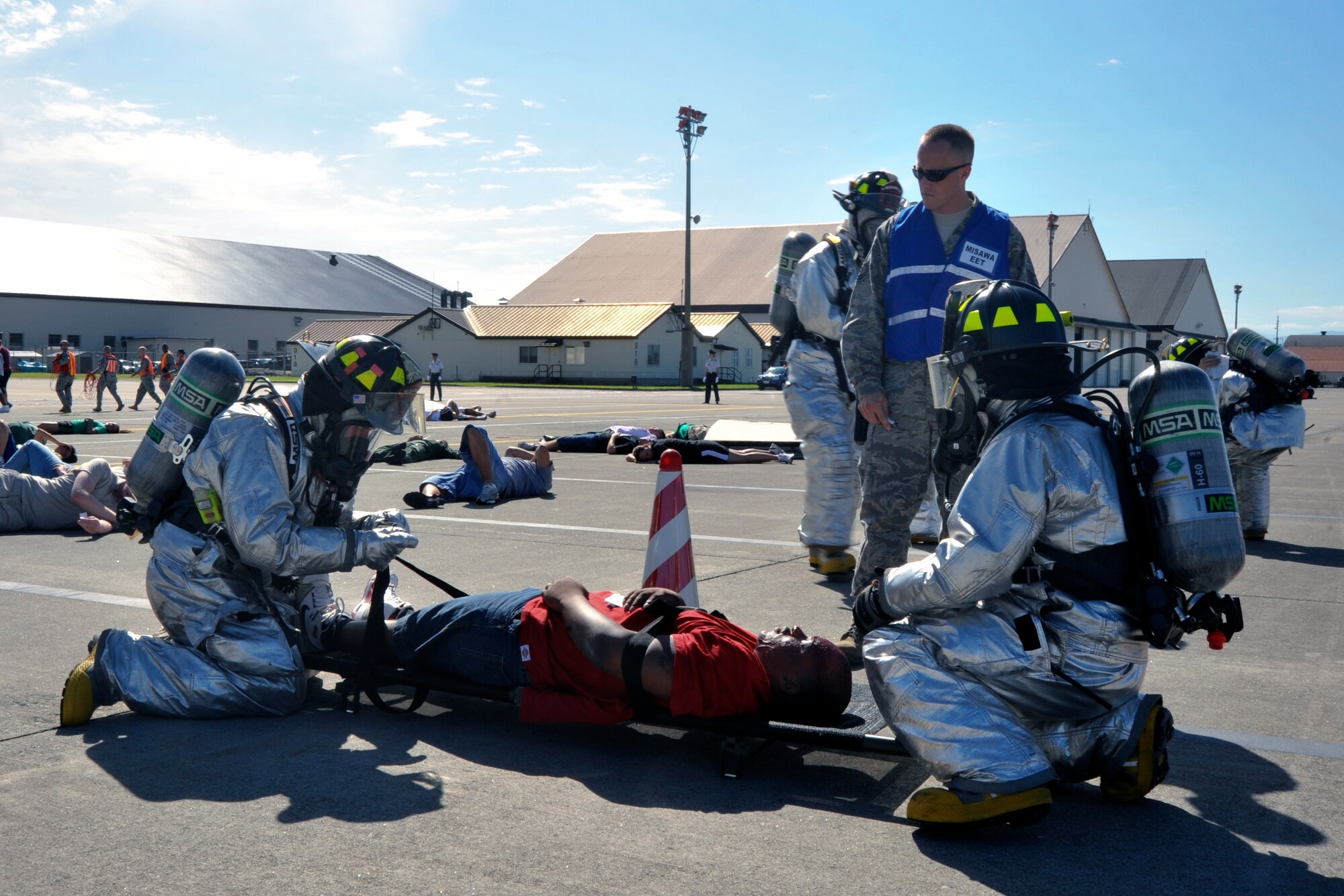 Air Force 35th Civil Engineer Squadron members, simulate rescuing victims during a major accident response exercise at Misawa Air Base, Japan, Sept. 8, 2010. Misawa AB and Japan Air Self-Defense Force combined rescue efforts as part of a joint exercise, which was geared to prepare the base in the event of a mishap during the Misawa Air Festival scheduled Sept. 19. (U.S. Air Force photo/Tech. Sgt. Russell McBride/Released)
