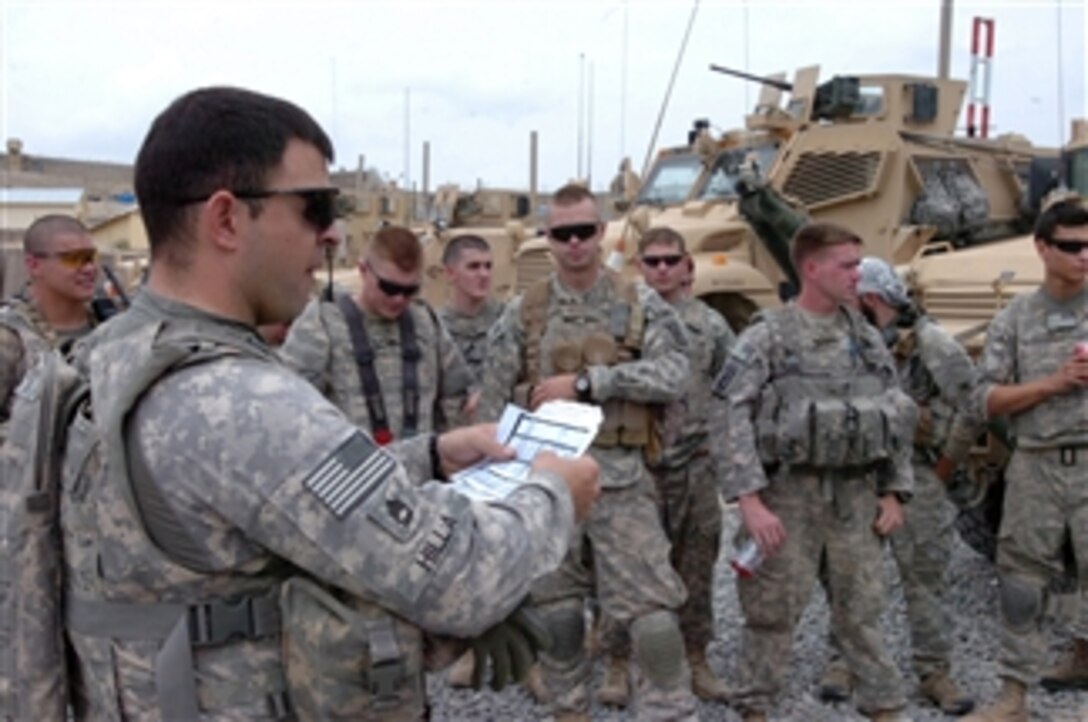 U.S. Army Sgt. 1st Class Hilla (2nd from left) with Attack Company, 1st Battalion, 503rd Infantry Regiment, 173rd Airborne Brigade Combat Team briefs his men before conducting a key leader engagement mission in Tangi district, Wardak province, Afghanistan, on Aug. 17, 2010.  
