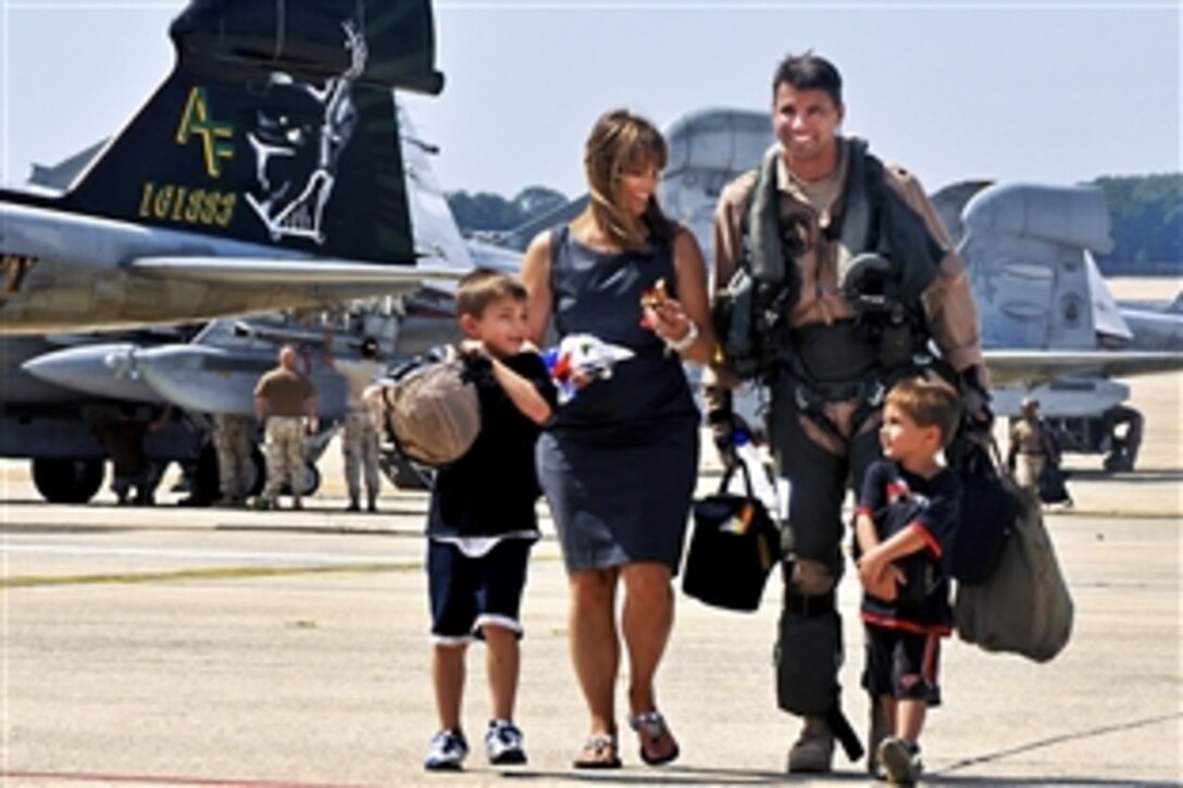 U.S. Navy Cmdr. Michael Esper leaves the flightline with his wife and children during a homecoming celebration on Joint Base Andrews Naval Air Facility, Md., Sept. 7, 2010. The squadron completed a three-month, forward-deployed tour to Afghanistan to support Operation Enduring Freedom. Esper is assigned to the Electronic Attack Squadron 209.