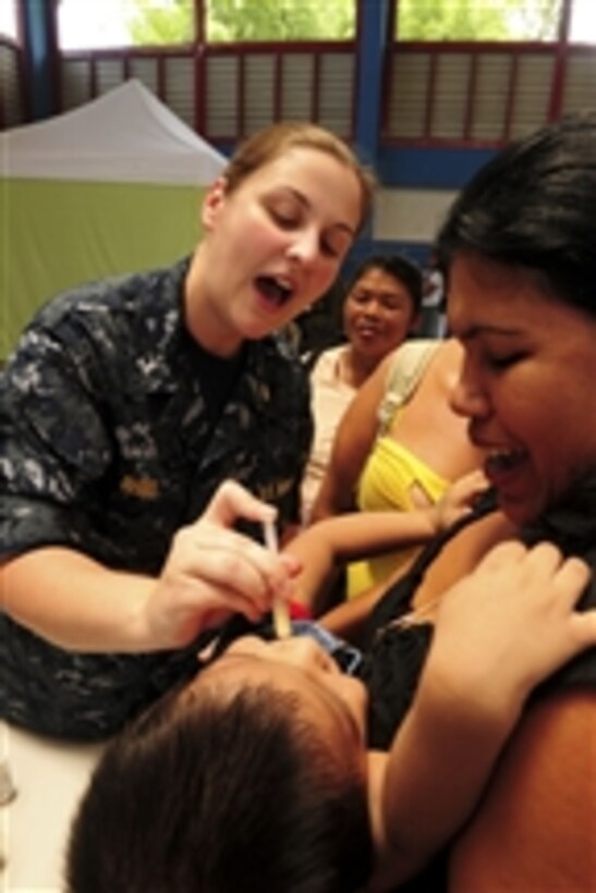 U.S. Navy Lt. j.g. Katt Rhine gives deworming medication to an infant during a Continuing Promise 2010 medical civic action program in Bribri, Costa Rica, on Aug. 25, 2010.  Assigned medical and engineering staff embarked aboard the amphibious assault ship USS Iwo Jima (LHD 7) worked with partner nation teams to provide medical, dental, veterinary and engineering assistance in eight nations as part of Continuing Promise.  
