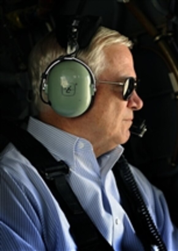 Secretary of Defense Robert M. Gates gazes out the window as he flies from Kandahar Airfield, Afghanistan, to Camp Nathan Smith, Afghanistan, in a U.S. Army UH-60 Black Hawk helicopter on Sept. 3, 2010.  