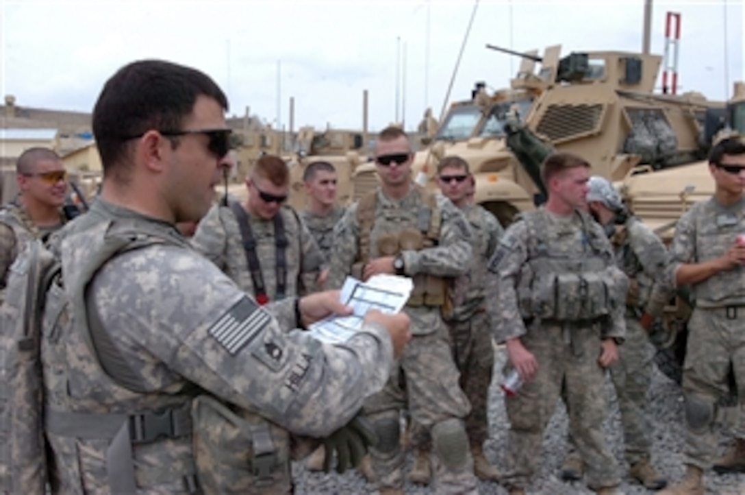 U.S. Army Sgt. 1st Class Hilla (2nd from left) with Attack Company, 1st Battalion, 503rd Infantry Regiment, 173rd Airborne Brigade Combat Team briefs his men before conducting a key leader engagement mission in Tangi district, Wardak province, Afghanistan, on Aug. 17, 2010.  