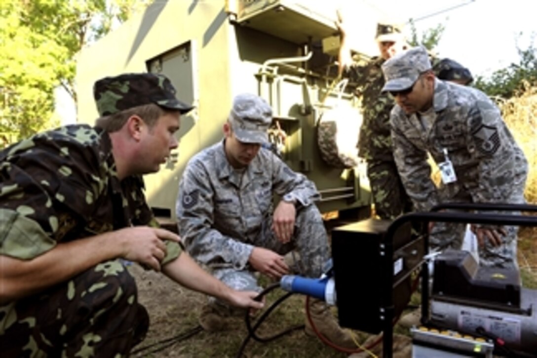 U.S. Airmen with 1st Combat Communications Squadron, Ramstein Air Base, Germany, help Ukrainian soldiers with communication equipment during Combined Endeavor 2010 at Mihail Kogalniceanu Air Base, Romania, on Sept. 2, 2010.  Combined Endeavor 2010 was a  large communications interoperability exercise.  It prepared international forces command, control, communications and computer systems for multinational operations.  