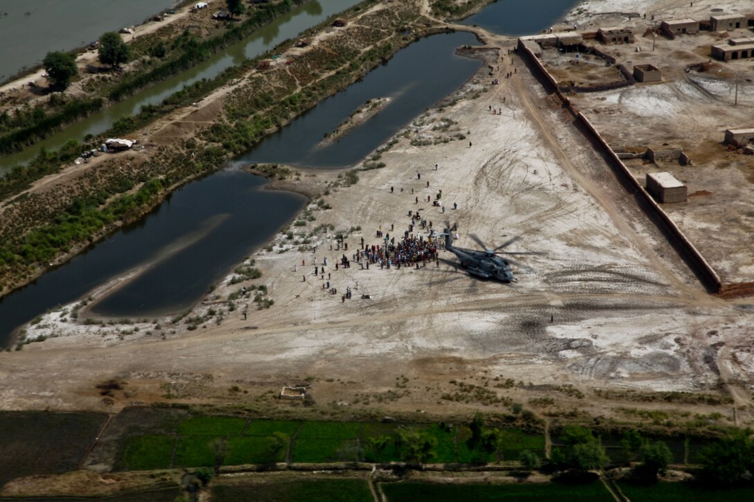 U.S. Marines with the 26th Marine Expeditionary use a CH-53 Super Stallion helicopter to deliver food to flood victims in Pano Aqil, Pakistan, Sept. 11, 2010. (U.S. Marine Corps photo by Staff Sgt. Wayne Gray/Released)