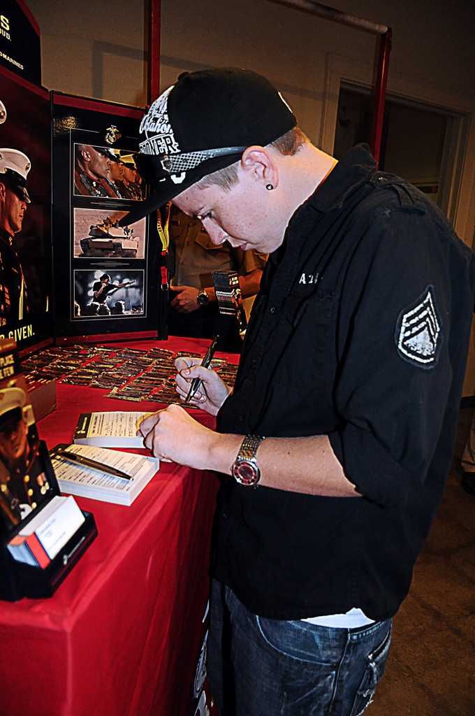 Ariel Pratt, 20, fills out a contact information card at the Marine Corps booth during the first military career fair hosted specifically for openly homosexual individuals at the Dennis R. Neill Equality Center, Tulsa, Okla., on Sept. 20, the first day of the historic repeal of the Don't Ask, Don't Tell policy.   After speaking with Marine recruiters Pratt was told she may not be eligible for enlistment due to medical disqualification.  Pratt was one of three applicants who spoke with Marines about the possibility of enlisting in the Corps.  The event brought considerable media attention from many different media outlets including ABC, CBS, NBC, Fox News, New York and LA Times.