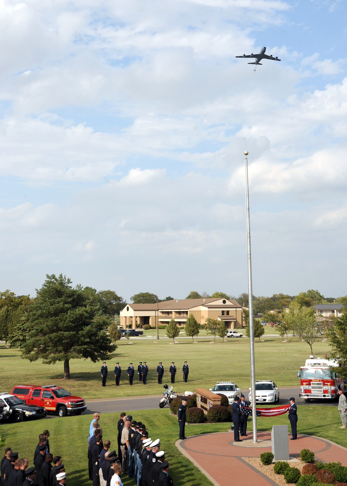 A KC-135 Statotanker flies over a retreat ceremony at the base flag pole at McConnell Air Force Base, Kan, Sept. 10, 2010.  Airmen from McConnell, along with police and fire department representatives from Sedgwick County, Butler County, Wichita, Derby and Rose Hill participated in the ceremony which honored the first responders and civilians who lost their lives during the Sept. 11, 2001, terrorist attacks.  (U.S. Air Force photo/Staff Sgt. Dallas Edwards)