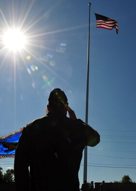 ALTUS AIR FORCE BASE, Okla. -- Col. Ty Thomas, 97th Air Mobility Wing commander, salutes as a new flag is raised during a September 11th memorial ceremony and formation at the Wings of Freedom Park on 10 Sept. (U.S. Air Force photo by Master Sgt. Brian M. Boisvert/ Released 97th Air Mobility Wing Public Affairs)