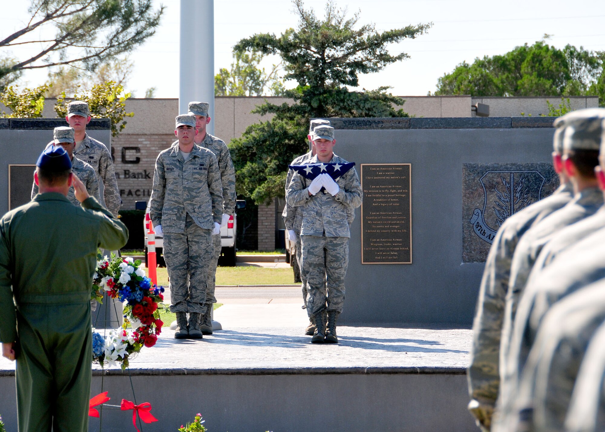ALTUS AIR FORCE BASE, Okla. -- Col. Ty Thomas, 97th Air Mobility Wing commander, salutes as a new flag is raised during a September 11th memorial ceremony and formation at the Wings of Freedom Park on Sept. 10. (U.S. Air Force photo by Master Sgt. Brian M. Boisvert/ Released 97th Air Mobility Wing Public Affairs)