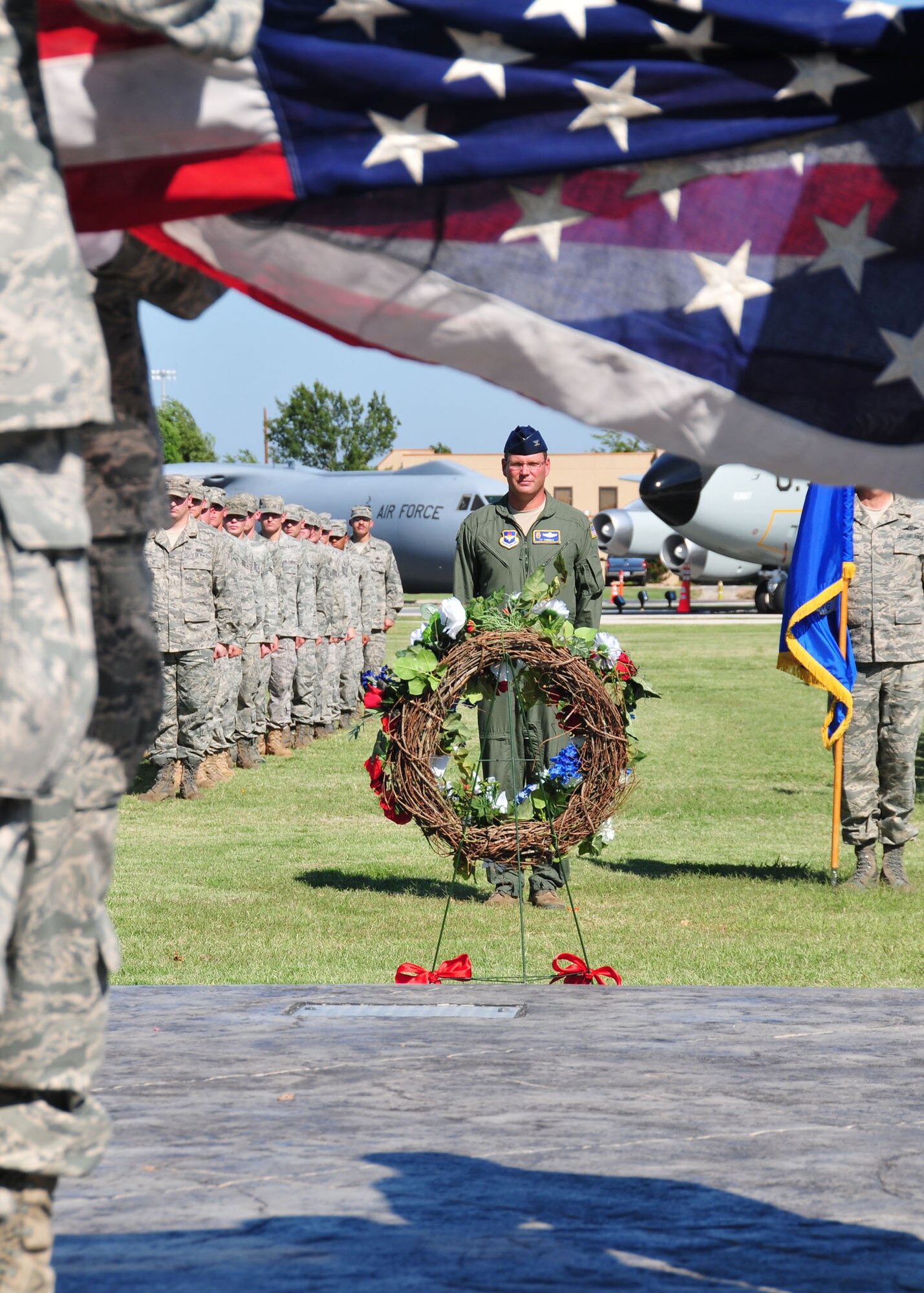 ALTUS AIR FORCE BASE, Okla. -- Col. Ty Thomas, 97th Air Mobility Wing commander, stands in formation as the base honor guard, The Blue Knights, retire the base flag during a September 11th memorial ceremony and formation at the base Wings of Freedom Park on Sept. 10. The flag was the original flag that was flying on the base 11 Sept 2001 and was flown again as part of the remembrance ceremony. (U.S. Air Force photo by Master Sgt. Brian M. Boisvert/ Released 97th Air Mobility Wing Public Affairs)