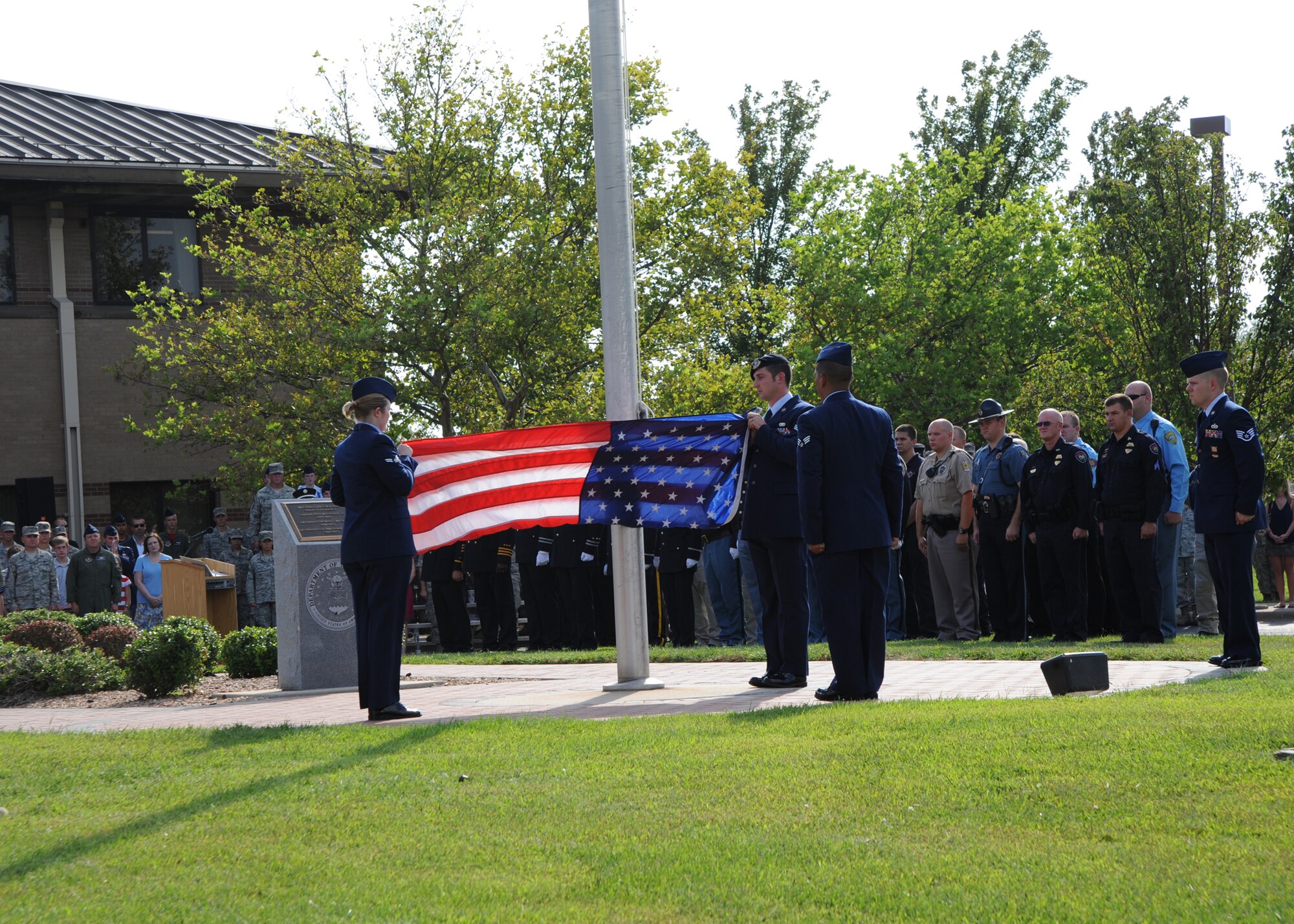 McConnell Airmen fold a flag during a Patriot Day Retreat Ceremony held at the base flagpole Sept. 10, 2010, McConnell Air Force Base, Kan.  The ceremony honors those who lost their lives during the Sept. 11, 2001, terrorist attacks.  It is held annually and included the ringing of the last alarm bell, a “21-gun salute” by the base honor guard, a bagpiper and a KC-135 Stratotanker flyover.  (U.S. Air Force photo/Airman 1st Class Andrea Salazar)