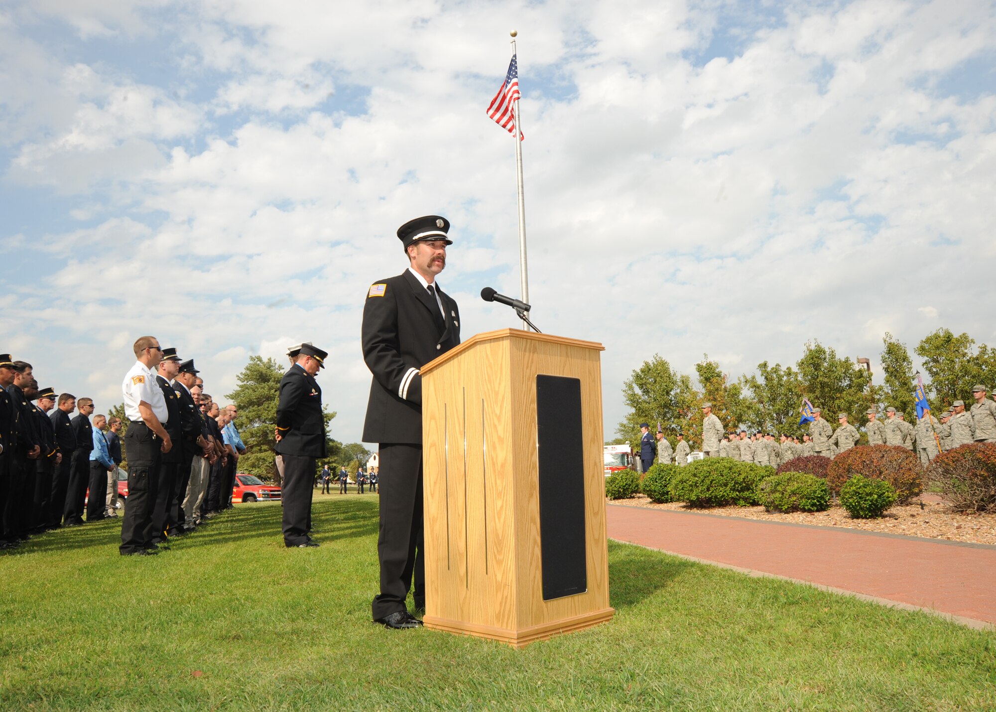 Richard Barnett, 22nd Civil Engineer Squadron firefighter, speaks to Team McConnell about honoring those who lost their lives during the Sept. 11, 2001, terrorist attacks, during a ceremony at the base flagpole, Sept. 10, 2010, McConnell Air Force Base, Kan. The formations at the ceremony consisted of base and community first responders.  (U.S. Air Force photo/Airman 1st Class Andrea Salazar)