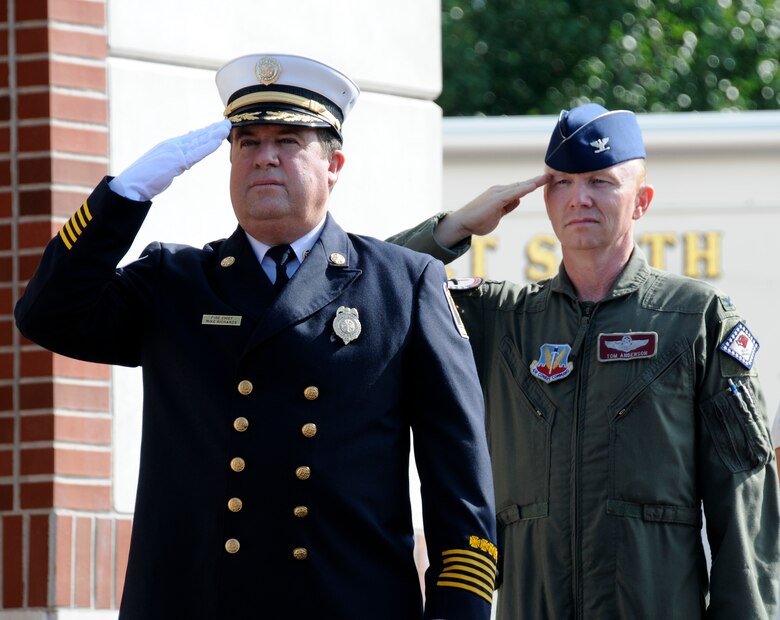 Col. Tom Anderson, 188th Fighter Wing commander, right, and Chief Mike Richards, fire chief of the Fort Smith Fire Department, salute the United States flag during the singing of the "Star Spangled Banner" at a  Sept. 11, 2001, remembrance gathering at the University of Arkansas-Fort Smith Sept. 10, 2010. (U.S. Air Force photo by Capt. Heath Allen/Arkansas National Guard Public Affairs)

