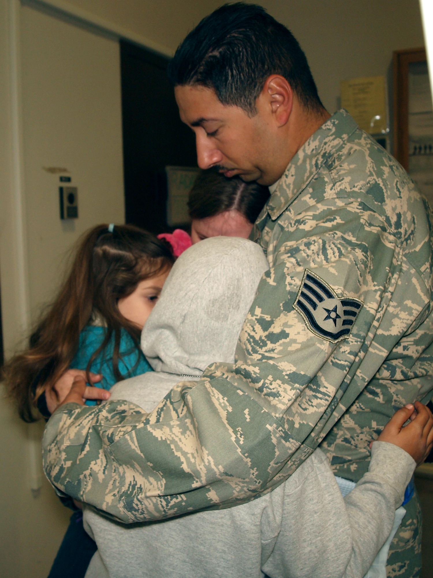 MOUNTAIN HOME AIR FORCE BASE, Idaho -- Staff Sgt. Salvador Medrano, 726th Air Control Squadron, hugs his family before departing for a deployment in support of Operation New Dawn Sept 6. The 726th ACS mission is to provide unparalleled air battle management to joint air, land and sea power anytime, anywhere. (Courtesy Photo)