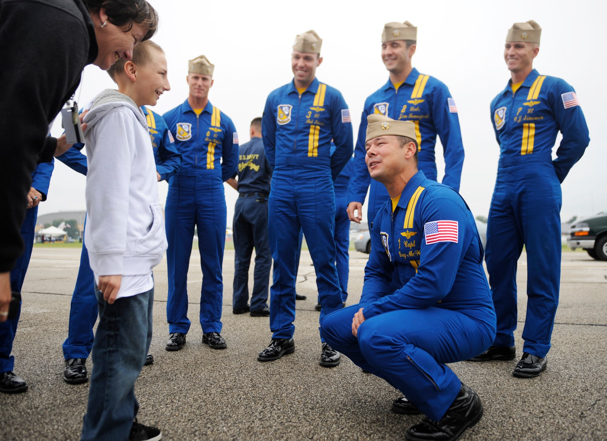 SCOTT AIR FORCE BASE, Ill. -- Capt. Greg McWherter, Blue Angels flight leader, speaks to Jordan Krantz whose wish as a part of the Make-A-Wish program was to meet a pilot, during the preview air show Sept 10. The preview air show catered to the elderly and those with special needs. While the flying portion of the show was canceled due to inclement weather, attendees were able to tour static aircraft, talk with pilots and crew and bounce houses were available for children. (U.S. Air Force photo/Staff Sgt. Ryan Crane)
