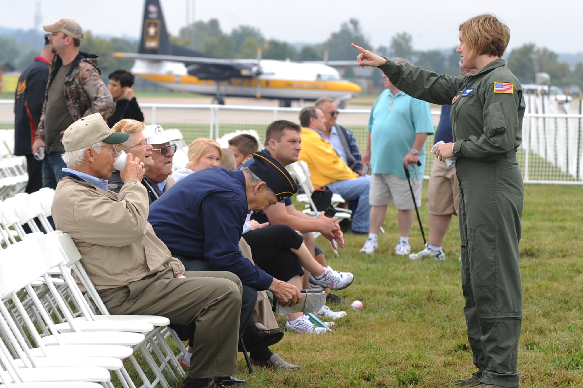 SCOTT AIR FORCE BASE, Ill. -- Master Sgt. Liz Wszalek helps the elderly with any questions they have during the preview air show Sept. 10.The preview air show catered to the elderly and those with special needs.  While the flying portion of the show was canceled due to inclement weather, attendees were able to tour static aircraft, talk with pilots and crew and bounce houses were available for children. (U.S. Air Force photo/Senior Airman Tristin English)