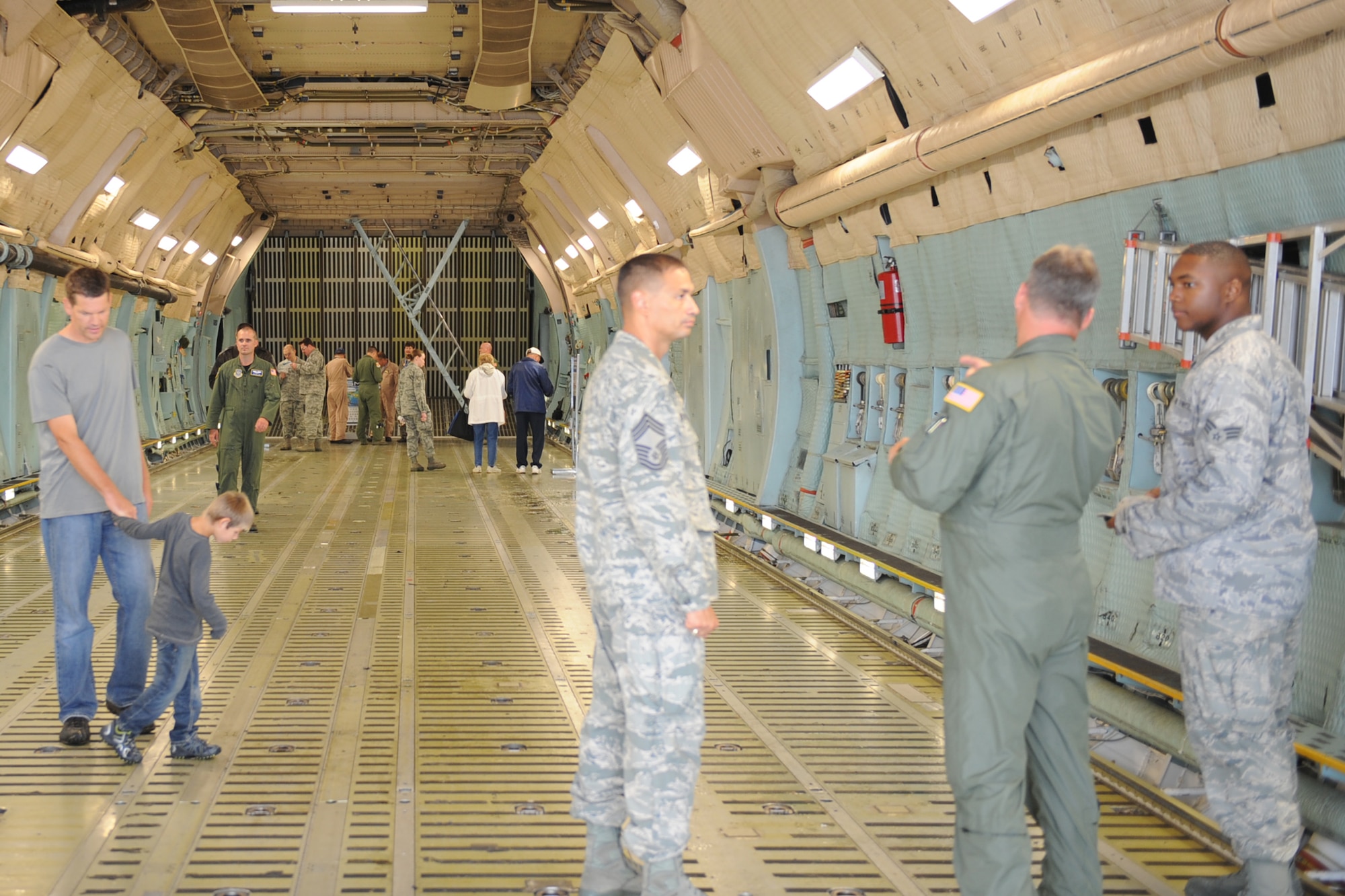 SCOTT AIR FORCE BASE, Ill. -- Members of Team Scott and their families stand inside of a C-5 Galaxy during the preview air show Sept. 10, 2010. The preview air show catered to the elderly and those with special needs.  While the flying portion of the show was canceled due to inclement weather, attendees were able to tour static aircraft, talk with pilots and crew and bounce houses were available for children. (U.S. Air Force photo/Senior Airman Tristin English)