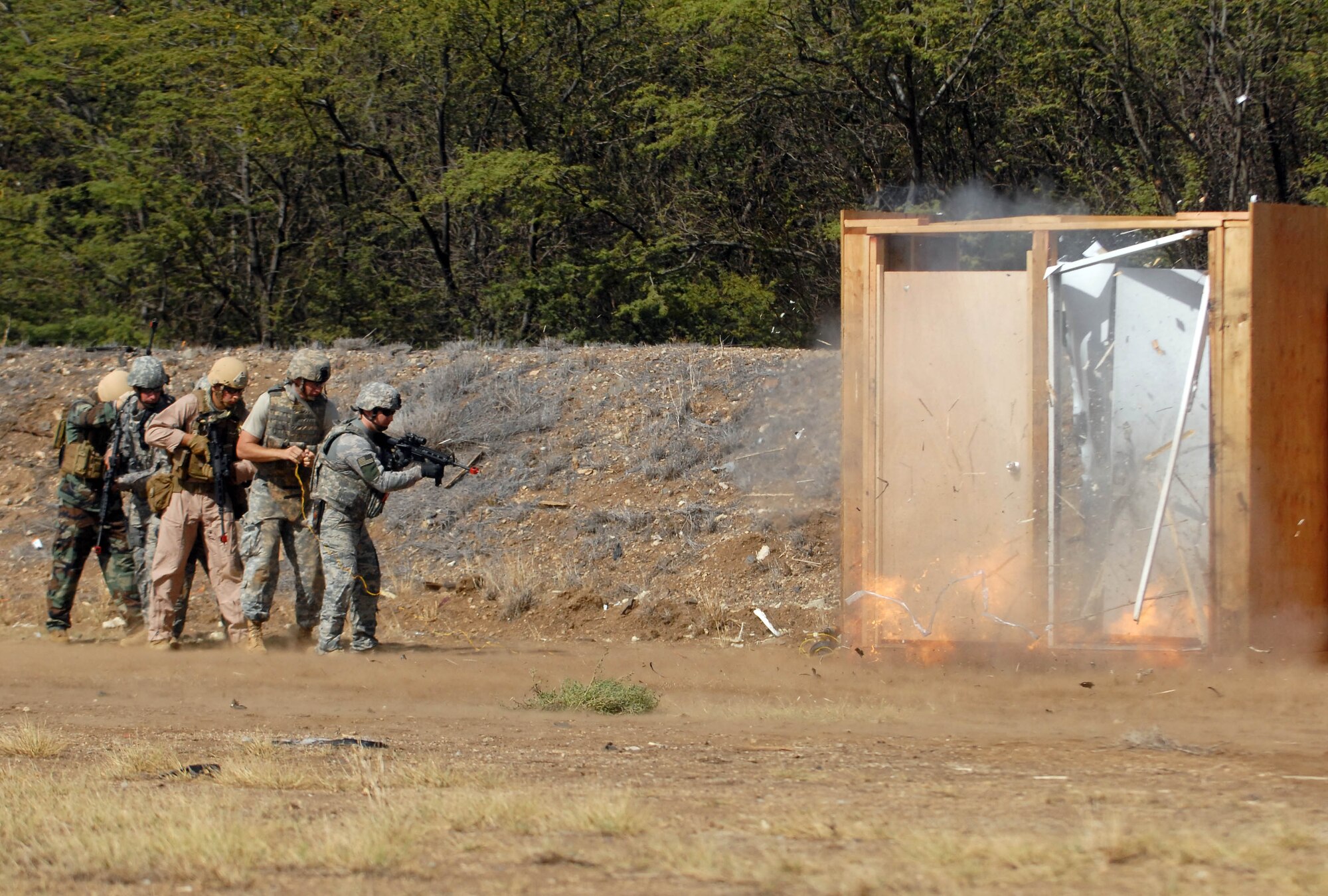 Airmen, Sailors, Soldiers, and Marines detonate explosives as part of breaching and entering training at Joint Base Pearl Harbor-Hickam Sept. 1, 2010. Airmen from the 647th Civil Engineer Squadron Explosive Ordnance Disposal flight hosted the 40-hour event, taught by an experienced civilian contractor. (U.S. Air Force photo/Staff Sgt. Carolyn Viss)