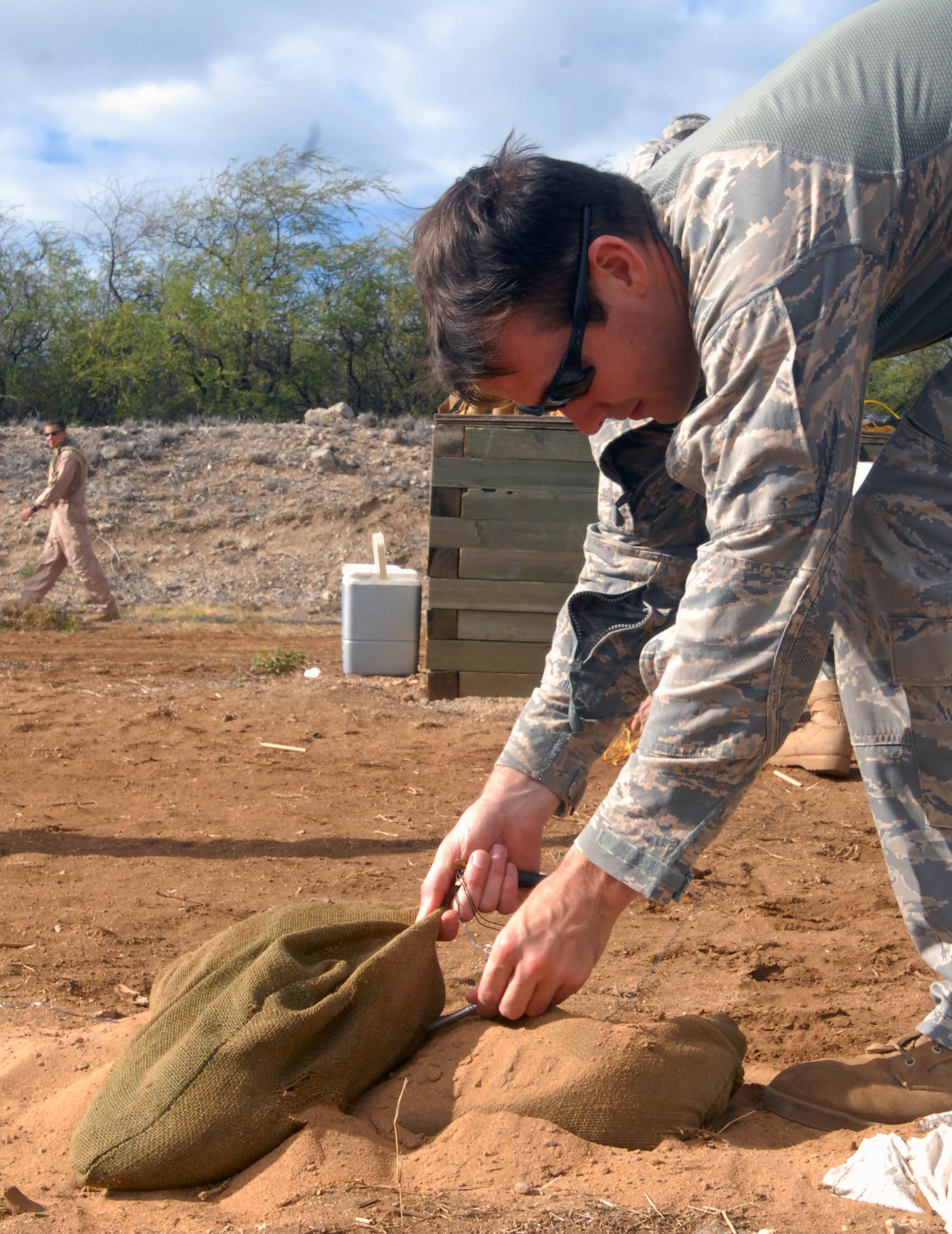 Senior Airman Marc Rowand-Donohue, a 647th Civil Engineer Squadron Explosive Ordnance Disposal technician, safely bunkers an electric blasting cap during a joint-service training event at Joint Base Pearl Harbor-Hickam Sept. 1, 2010. Airmen hosted the 40-hour training event, which focused on breaching and entering techniques. (U.S. Air Force photo/Staff Sgt. Carolyn Viss)