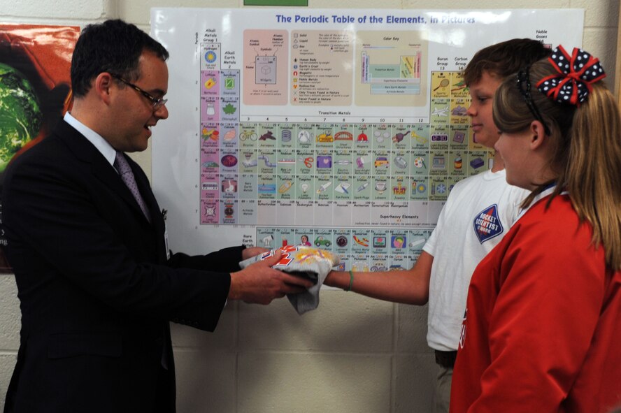 BARKSDALE AIR FORCE BASE, La. --  Megan Jetton and Brennon Bockhaus, STARBASE Louisiana students, present the Honorable Daniel B. Ginsberg, assistant secretary of the Air Force for manpower and Reserve affairs, a STARBASE tee shirt on behalf of their classmates Sept. 9. Mr. Ginsberg is responsible for providing overall supervision of manpower, military and civilian personnel, Reserve component affairs, and readiness support for the Department of the Air Force. (U.S. Air Force photo/Senior Airman Brittany Y. Bateman)(RELEASED)