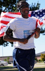 LANGLEY AIR FORCE BASE, Va – Master Sgt. Brian Nixon, 82nd Communications Support Squadron team member, crosses the finish line of the 9/11 memorial run Sept. 10, 2010. Ten teams, each consisting of 11 people, ran a total of 550 miles with each member running a five-mile loop. (U.S. Air Force photo/Staff Sgt. Tabitha Kuykendall)(RELEASED)