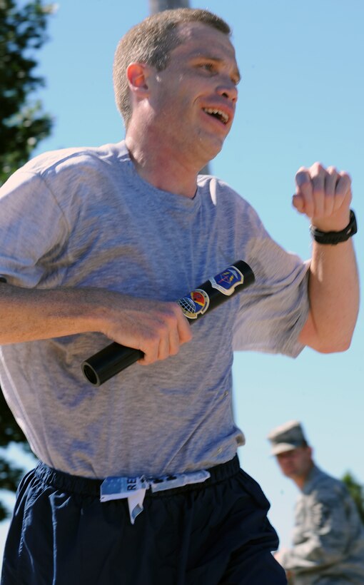 LANGLEY AIR FORCE BASE, Va – Maj. Joel Fenlason, Headquarters ACC “Team Vorticity” team member, crosses the finish line of the 9/11 memorial run Sept. 10, 2010. Team Vorticity was the first team to have all members cross the finish line, giving them in first place. (U.S. Air Force photo/Staff Sgt. Tabitha Kuykendall)(RELEASED)