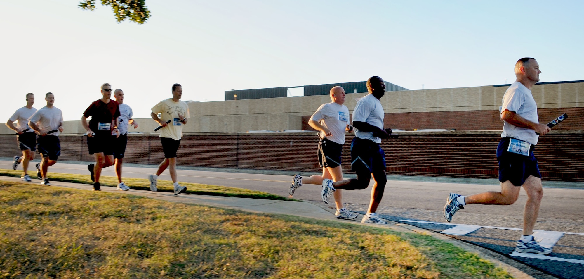 LANGLEY AIR FORCE BASE, Va – Joint Base Langley-Eustis runners take off at the start of a 9/11 memorial run Sept. 10, 2010. 633d Civil Engineer Squadron hosted the run in memoriam of the 55 military personnel that gave their lives on Sept. 11.  Ten teams, each consisting of 11 people, ran a total of 550 miles with each member running a five-mile loop.   (U.S. Air Force photo/Staff Sgt. Tabitha Kuykendall)(RELEASED)