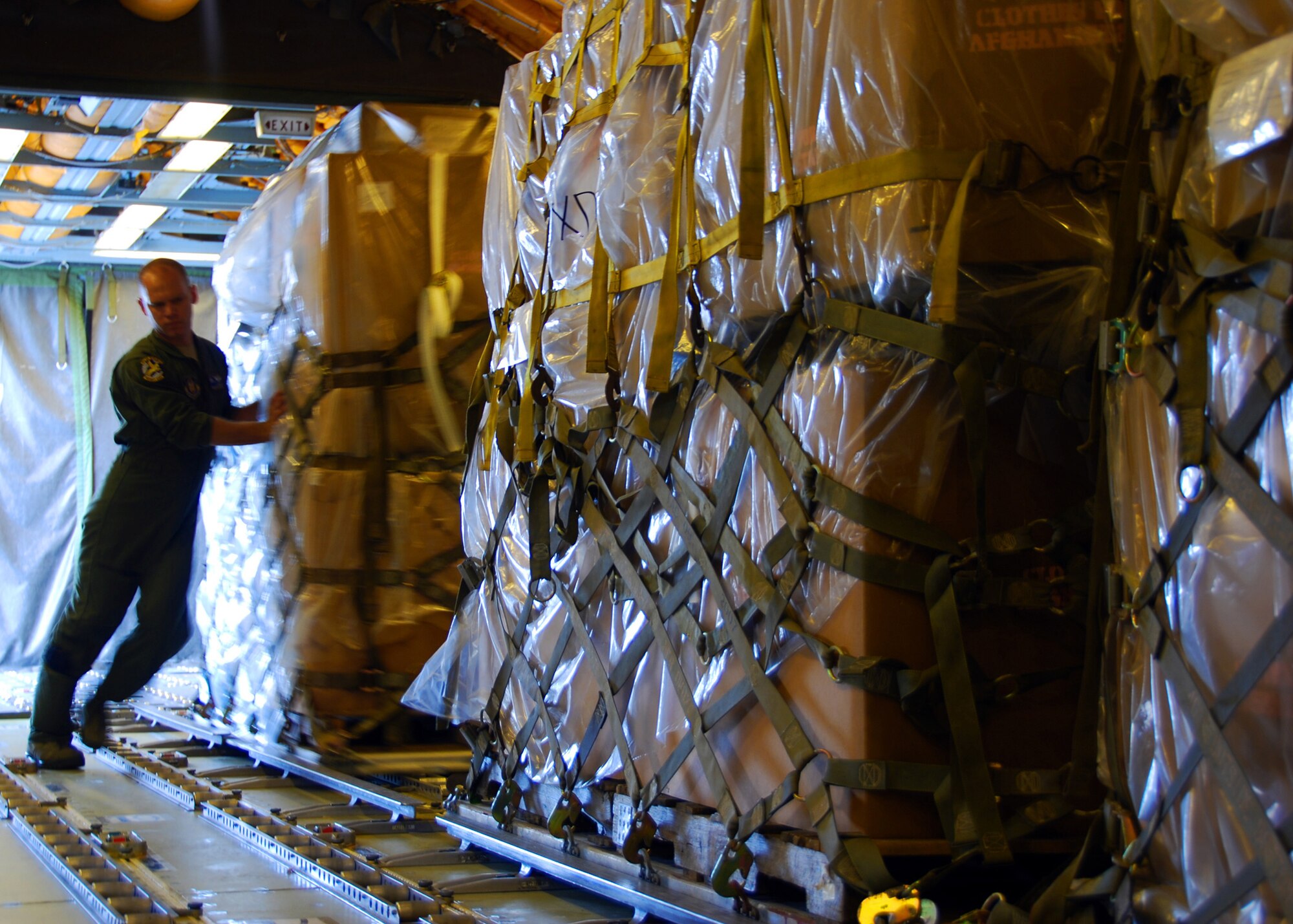 SEYMOUR JOHNSON AIR FORCE BASE, N.C. ? First Lt. Christopher McMenamy, a KC-10 pilot from 76th Air Refueling Squadron, helps load humanitarian cargo onto his aircraft here Sept. 2. The humanitarian cargo consisted of winter clothing, shoes and blankets which will be distributed to villages and orphanages near Kabul, Afghanistan.  Lieutenant McMenamy is a reservist serving at Joint Base McGuire-Dix-Lakehurst, N.J. (U.S. Air Force photo/Staff Sgt. Shawn J. Jones)