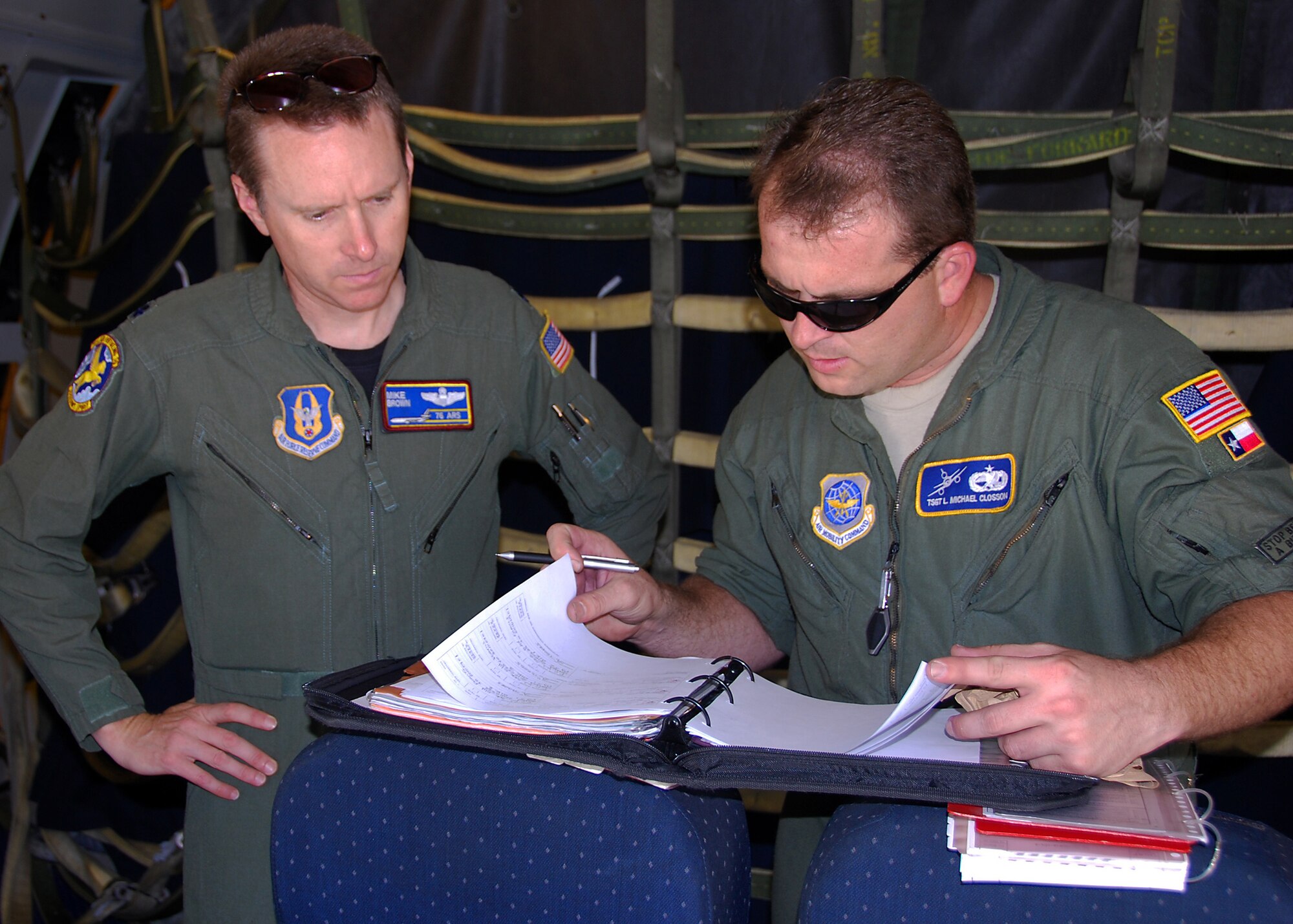 JOINT BASE MCGUIRE-DIX-LAKEHURST, N.J. ? Lieutenant Col. Mike Brown (left), a KC-10 pilot from the 76th Air Refueling Squadron, reviews aircraft maintenance documents provided by Tech. Sgt. Michael Closson, 605th Aircraft Maintenance Squadron crew chief, prior to a humanitarian mission to Seymour Johnson Air Force Base, N.C., Sept. 2. The mission's objective was to help transport winter gear from Seymour Johnson AFB to orphanages and villages in Afghanistan while providing a training opportunity for loading cargo. (U.S. Air Force photo/Staff Sgt. Shawn J. Jones)