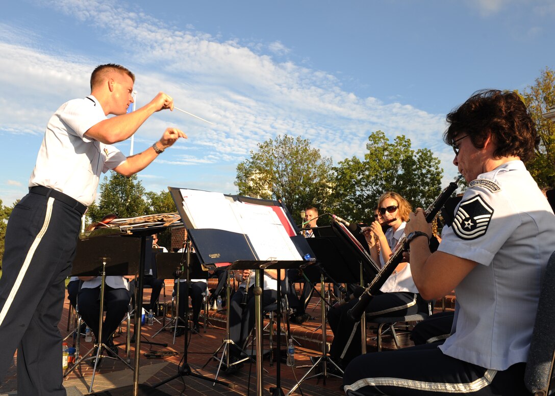 Lt. Dustin Doyle, deputy commander of the USAF Band of Mid-America, conducts the concert band during the final performance of the Scott Air Force Base Summer at Scott series.