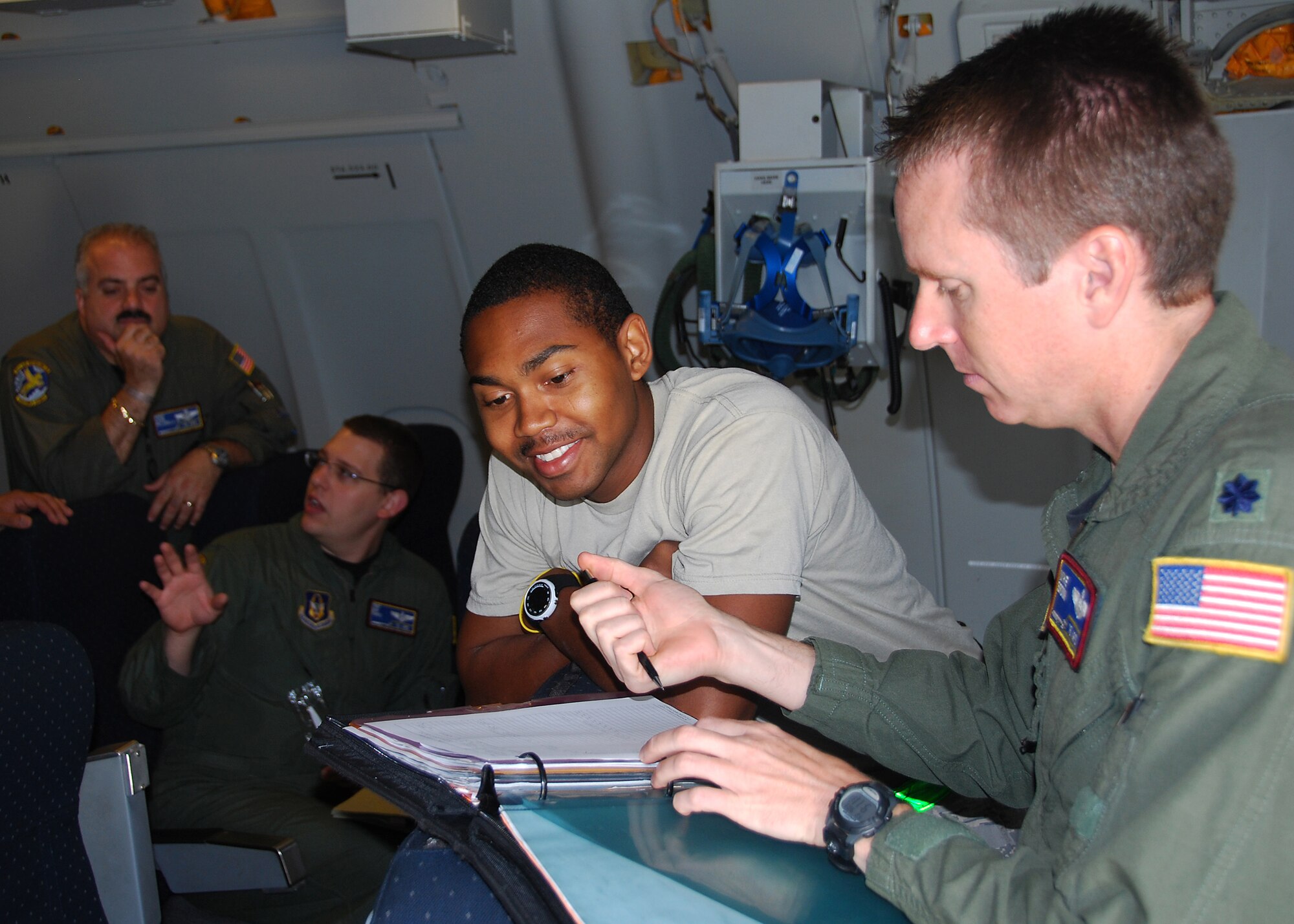 JOINT BASE MCGUIRE-DIX-LAKEHURST, N.J. ? Lieutenant Col. Mike Brown (right), a KC-10 pilot from the 76th Air Refueling Squadron, reviews aircraft maintenance documents provided by Airman 1st Class Devon Muse, 605th Aircraft Maintenance Squadron crew chief, after completing a humanitarian mission to Seymour Johnson Air Force Base, N.C., Sept. 3. The mission's objective was to help transport winter gear from Seymour Johnson AFB to orphanages and villages in Afghanistan. It also provided a training opportunity for loading cargo. Master Sgt. Louis Pillarella (left) and Tech. Sgt. Daniel Timko, both from the 76th ARS, are pictured in the background. (U.S. Air Force photo/Staff Sgt. Shawn J. Jones)