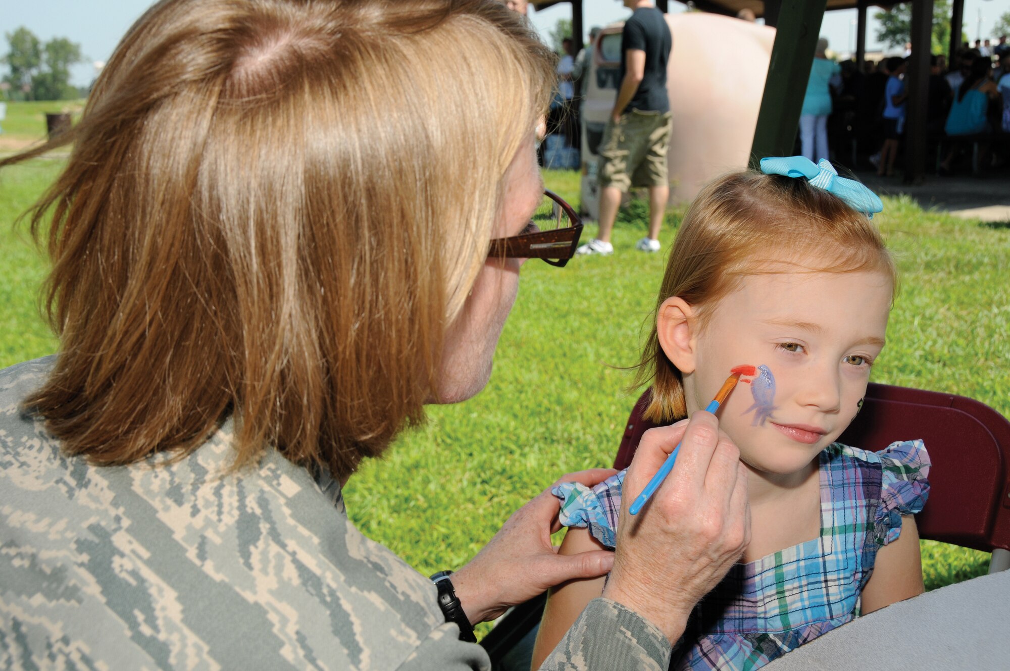 Lt. Col. Anne Yelderman, former 442nd Maintenance Squadron commander, now 442nd Mission Support Group deputy commander, paints faces during a maintenance group picnic at Skelton Park during the August unit training assembly. The 442nd MXS and MSG are part of the 442nd Fighter Wing, an Air Force Reserve unit at Whiteman Air Force Base, Mo. (U.S. Air Force photo/Staff Sgt. Tom Talbert)