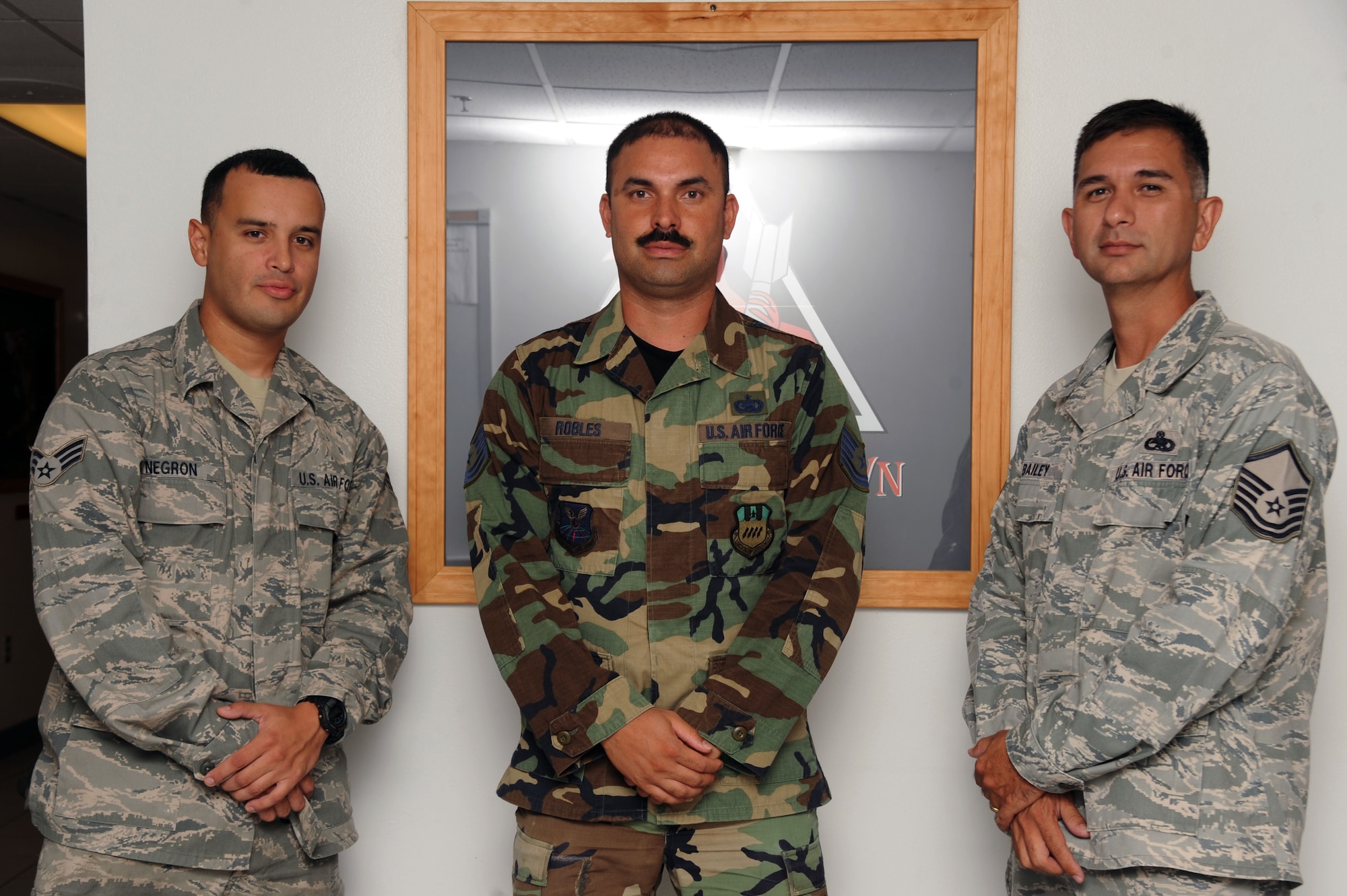 Senior Airman Eduardo Negron, Tech. Sgt. Juan Robles and Master Sgt. Patrick Bailey, all of 2nd Aircraft Maintenance Squadron, will be awarded safety awards and the Air Force achievement medal for the actions during an aircraft fire. The fire-fighting crewchiefs not only contained the fire to ensure safe evacuation of all six crew members, but also minimized damage to the aircraft. (U.S. Air Force photo/Senior Airman Brittany Y. Bateman)(RELEASED)