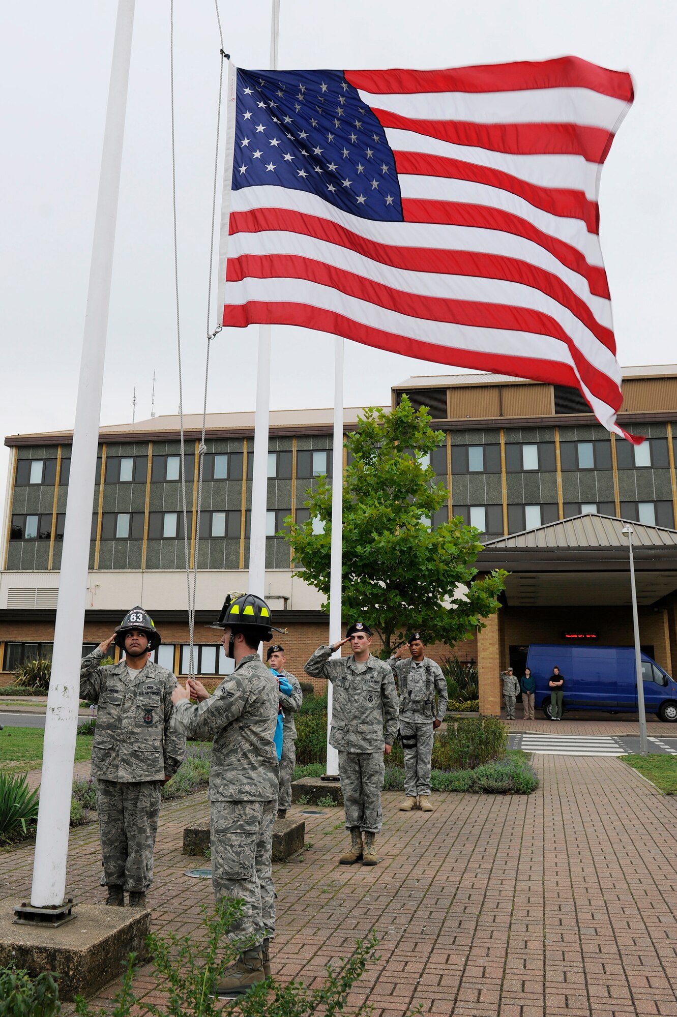 ROYAL AIR FORCE LAKENHEATH, England – Liberty Wing warriors salute the American flag during the 9/11 Retreat Ceremony, Sept. 10, 2010. The flags were folded by members of the 48th Security Forces Squadron and the 48th Civil Engineer Squadron in honor of those who responded to the attack. (U.S. Air Force photo/Airman 1st Class Lausanne Morgan)