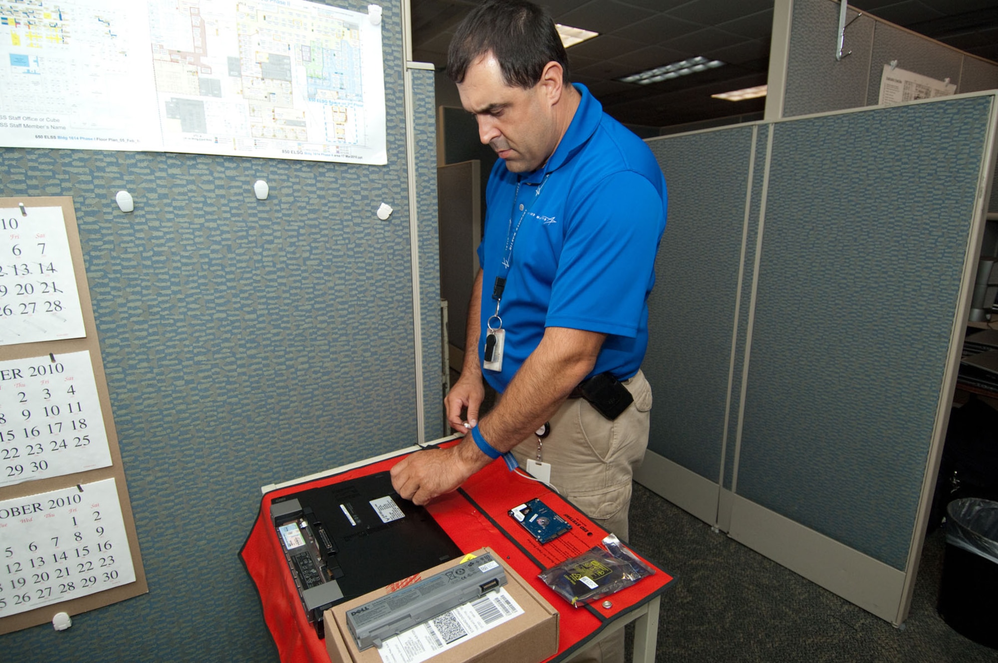 HANSCOM AIR FORCE BASE, Mass. –Bill James, a client system technician, works on a computer hard drive in the Response Center, which will soon become the Client Service Center, on Aug. 31. The Air Force cyberspace support workforce is undergoing a transformation. Base personnel are encouraged to call 3-HELP instead of going directly to client support administrators in order to get desktop computer assistance. (U.S. Air Force photo by Rick Berry)