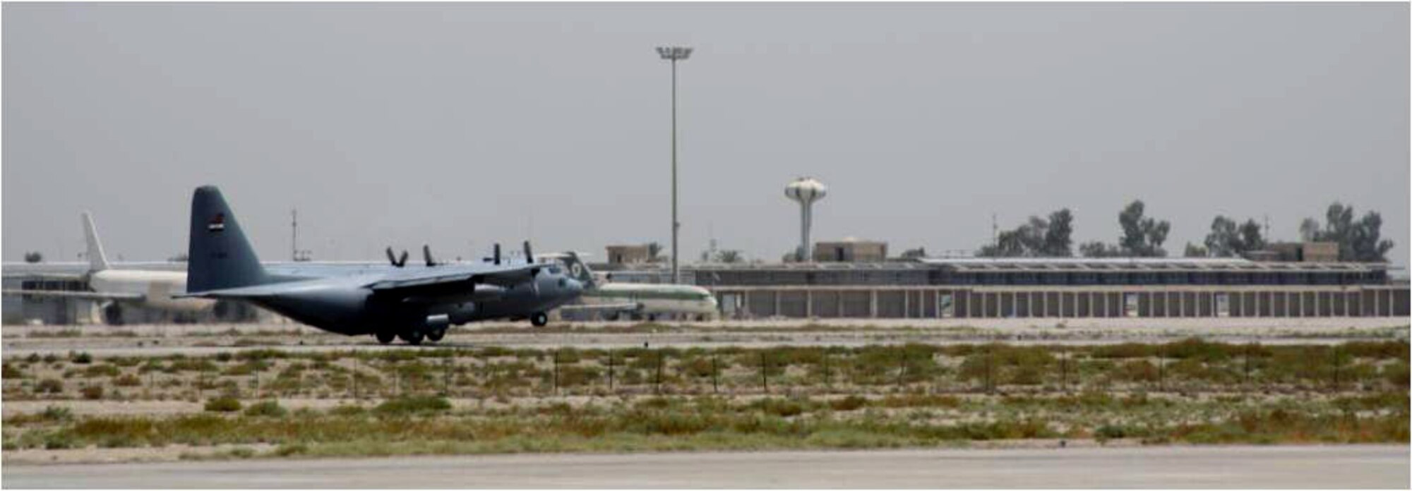 An Iraqi C-130 takes off from New Al Muthana Air Base, Baghdad, with the inaugural class of cadets bound for the recently re-built Iraqi Air Force College.  The Air Force College, located at Tikrit Air Base, Iraq, recently opened and accepted its first class of students on September 1.  The opening of this institution is the latest accomplishment of the Iraqi Air Force along the path to achieving self-sustaining airpower capabilities.  (U.S. Air Force photo)