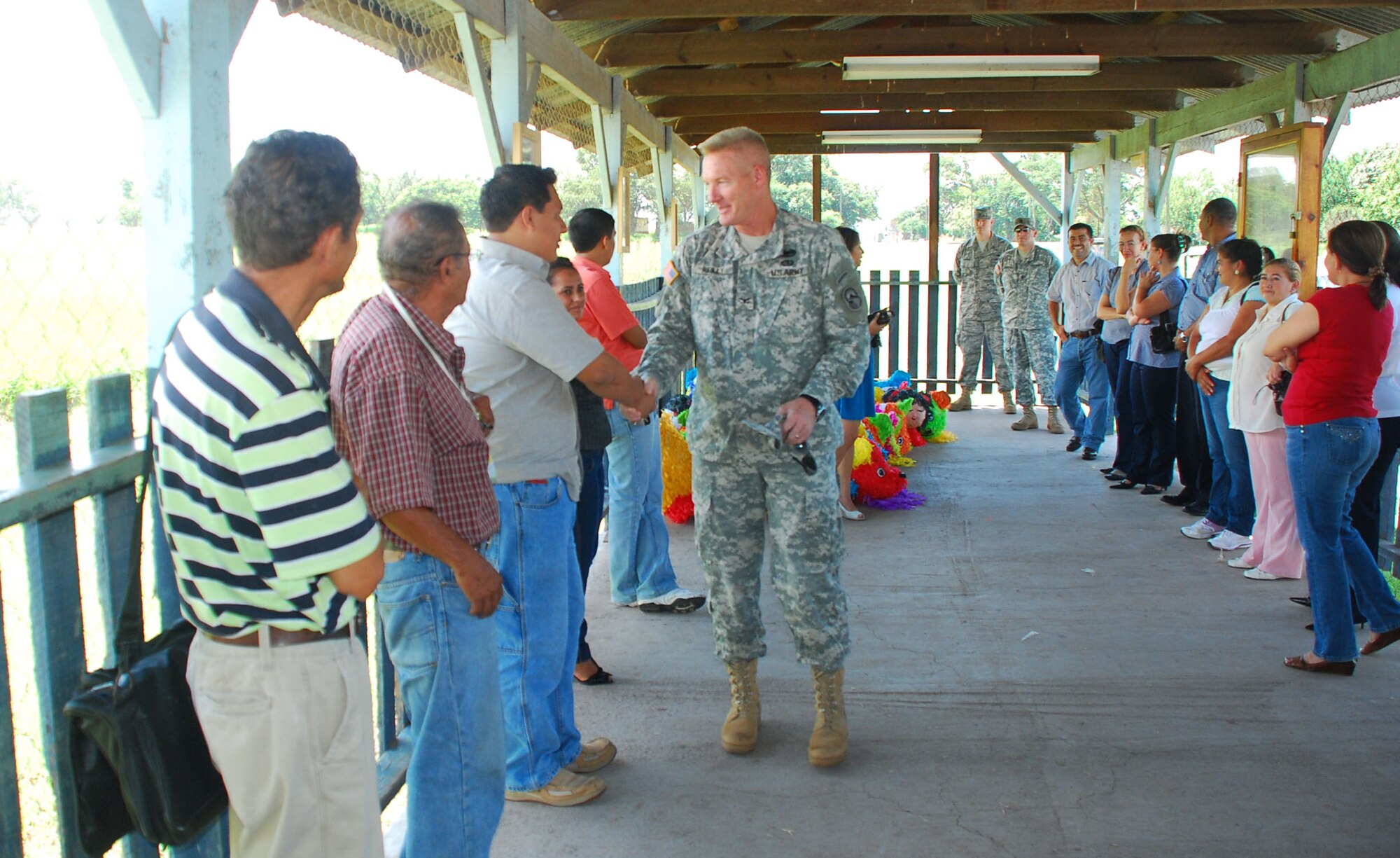 SOTO CANO AIR BASE, Honduras --  Col. Gregory Reilly, the Joint Task Force-Bravo commander, greets representatives from local schools Sept. 8 as they come to pick up piñatas donated by Team Bravo. Civil Affairs here purchased the piñatas and JTF-Bravo volunteers filled them with candy and other treats in celebration of Honduras' Children's Day, which takes place Sept. 10. (U.S. Air Force photo/Martin Chahin)