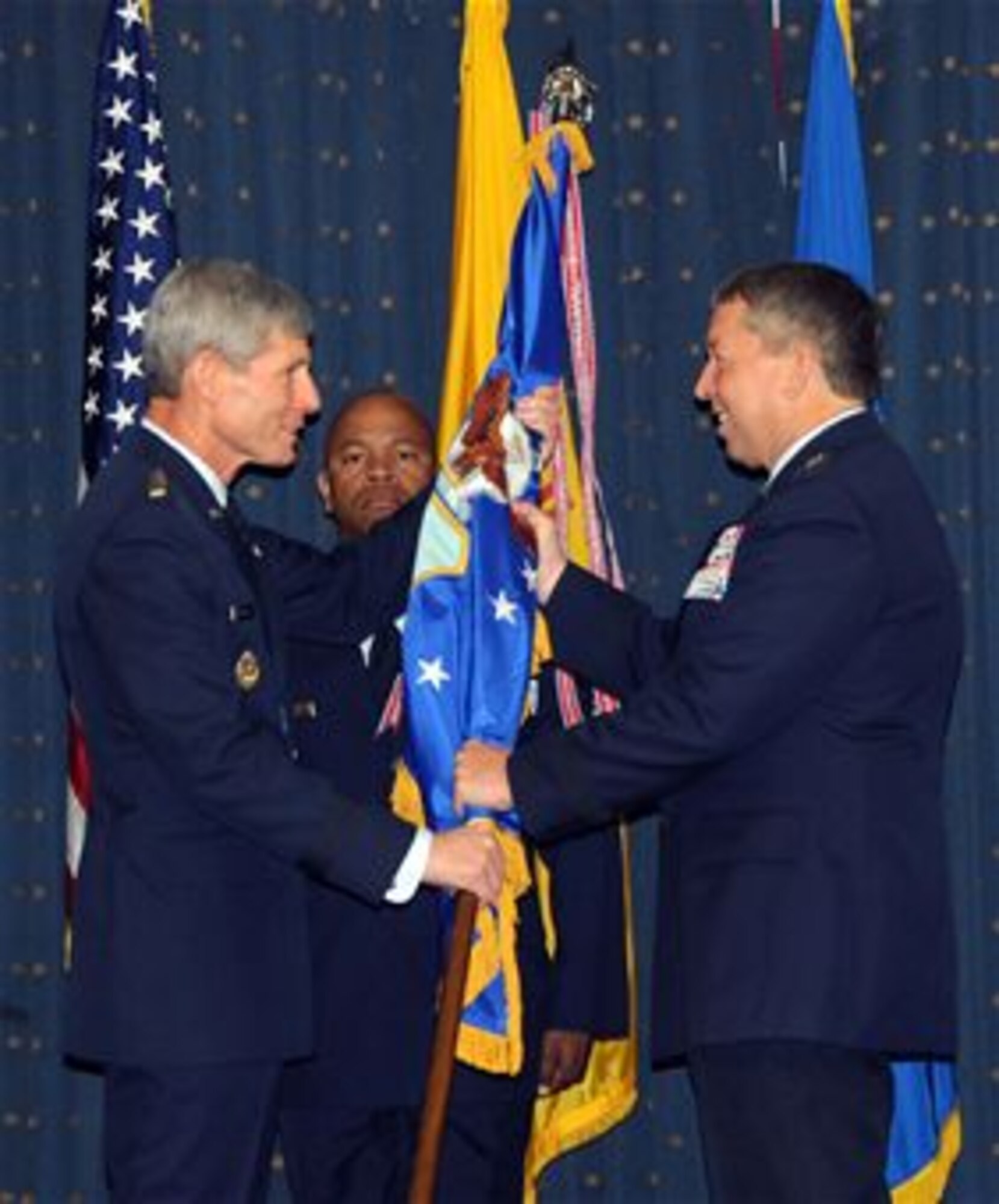 Air Force Chief of Staff Gen. Norton Schwartz (left) passes the Air Force Safety Center guidon to Maj. Gen. Gregory A. Feest in a change-of-command ceremony on Sept. 1, 2010, at Kirtland Air Force Base, N.M.  General Feest, now the Air Force chief of safety also is the new safety center commander.  (U.S. Air Force photo/Dennis Carlson)