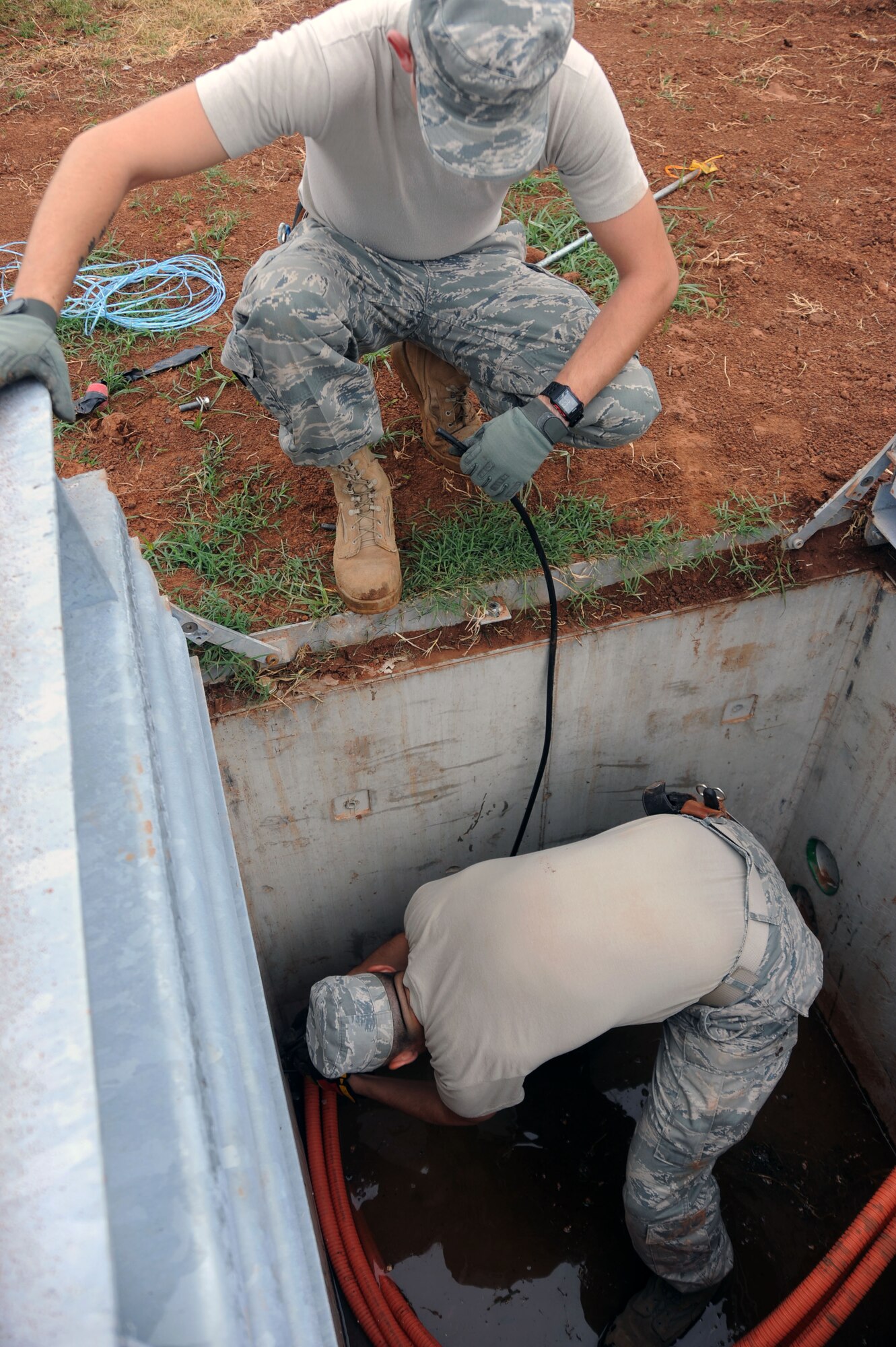 BARKSDALE AIR FORCE BASE, La. -- Senior Airman Ezekiel Newman, 2nd Communications Squadron antenna systems journeyman, watches as Airman 1st Class David Montroy, 2nd CS cable and antenna systems apprentice pulls out the pull rope from the innerduct so they can start pulling the cable through Sept. 9. The 2nd CS most important role is ensuring that the critical systems providing the command and control path for Barksdale?s combatant forces are always ready. (U.S. Air Force photo by Senior Airman Brittany Y. Bateman)(RELEASED)