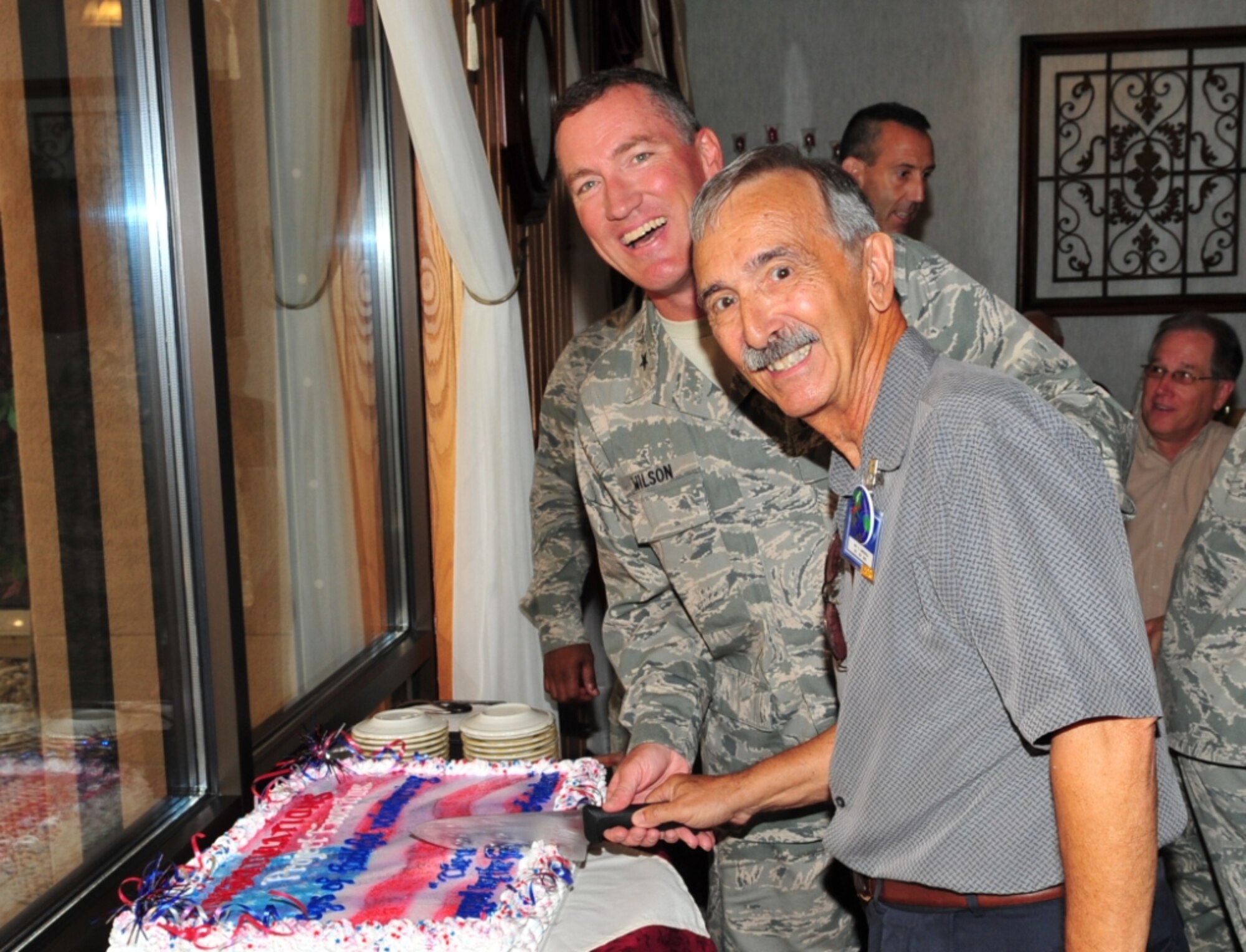 Brig. Gen. Ed Wilson, left, commander, 45th Space Wing, happily participates in the cake-cutting ceremony celebrating Project Emeritus’ 20th anniversary here Sept. 1 at the Riverside Dining Facility. Helping the Wing commander is Sam Lauricella, volunteer center director. This group is always looking for more people to assist with agencies and offices all around the Wing. If you want to offer your experience, do so by calling their office at 494-7656. “Bottom line up front; this Wing would not operate like it does without the help of these selfless volunteers. Our hats go off to each and every one of you,” said Brig. Gen. Wilson to the crowd of volunteers.