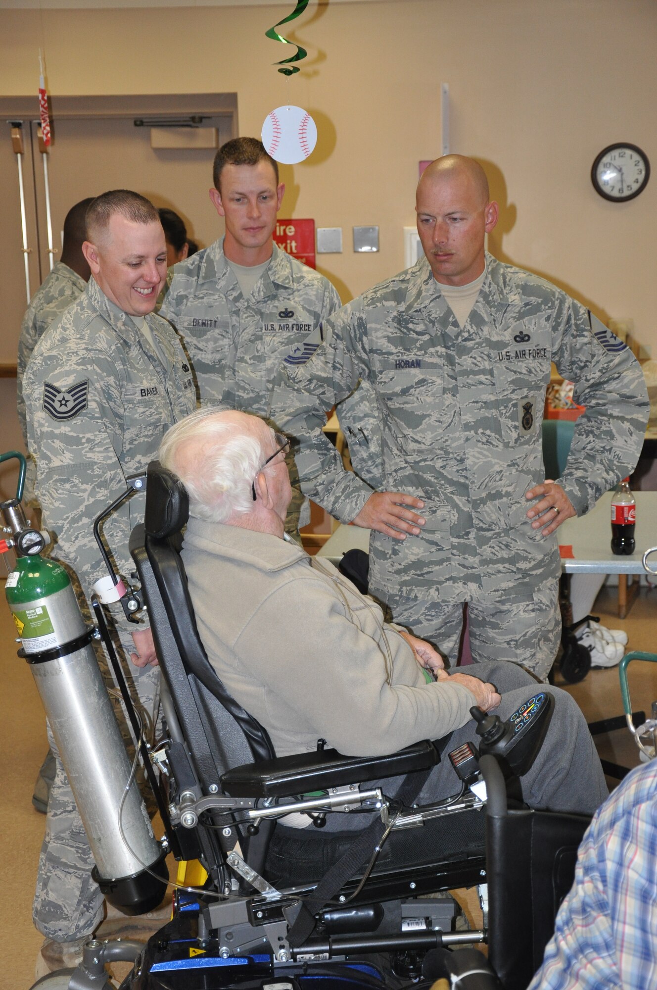Tech. Sgt. Andrew Baker, Tech. Sgt. Timothy Dewitt and Master Sgt. James Horan, all with the 90th Security Support Squadron, visit with Ronald Lanning, an Army veteran, during the monthly Top Three sponsored visit to Cheyenne’s Veteran’s Affairs Medical Clinic on Sept. 2. (U.S. Air Force photo by Dan Gage)
