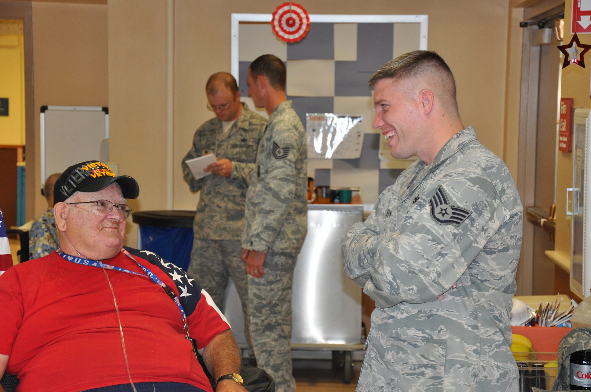 Richard Morissette and Staff Sgt. Roger Rapson, 90th Security Support Squadron, share stories and a laugh during the Top Three sponsored visit to Cheyenne’s Veteran’s Affairs Medical Clinic on Sept. 2. (U.S. Air Force photo by Dan Gage)