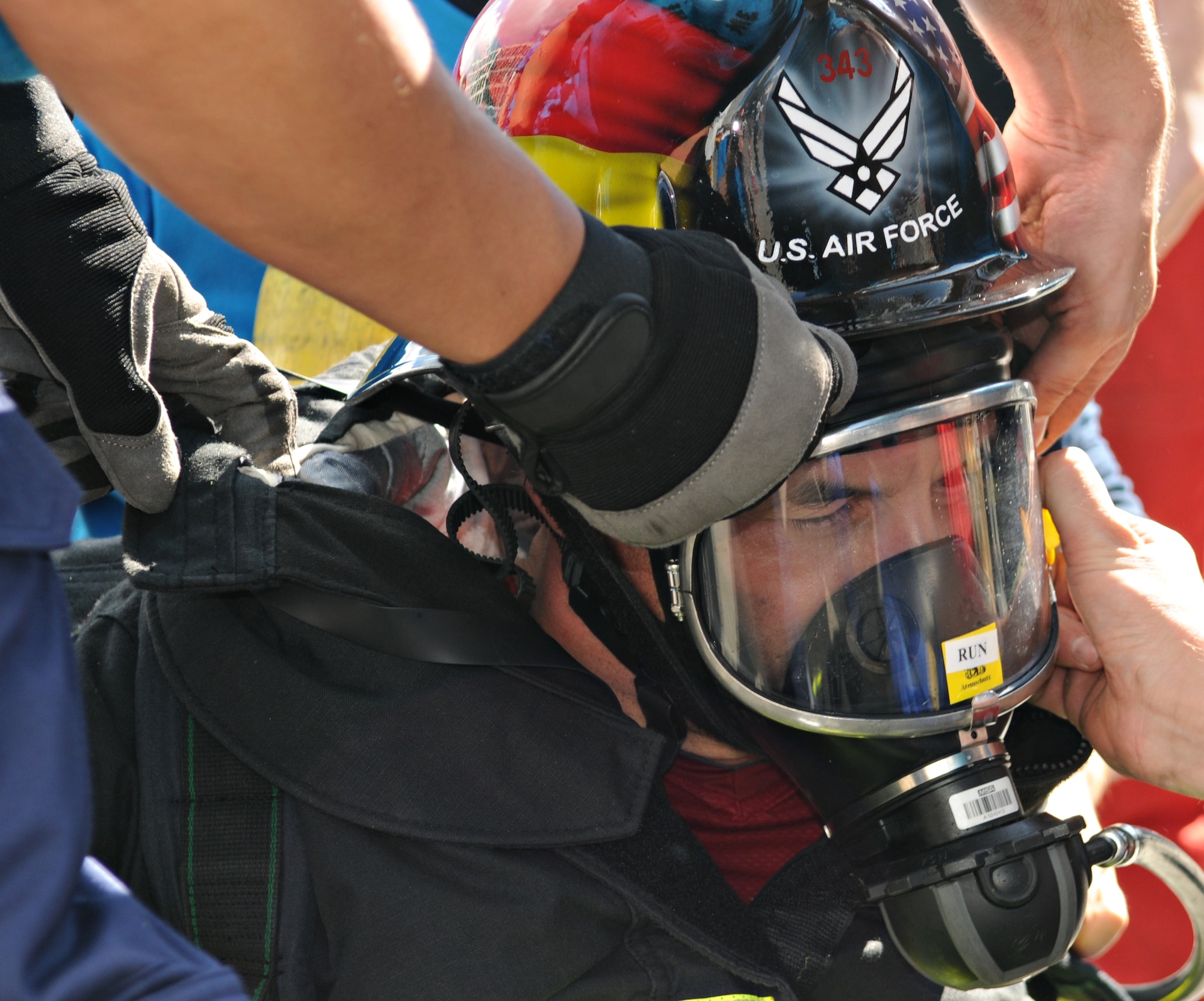BERLIN – Staff members remove firefighting gear from Gerd Mueller, 52nd Civil Engineer Squadron fire crew chief, after his individual race in the fourth Berlin firefighting Combat Challenge Sept. 4. Mr. Mueller earned second place in the over 40 age group with a finish time of 2 minutes, 8 seconds. (U.S. Air Force photo/Staff Sgt. Benjamin Wilson)